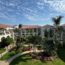 a building with palm trees and a walkway