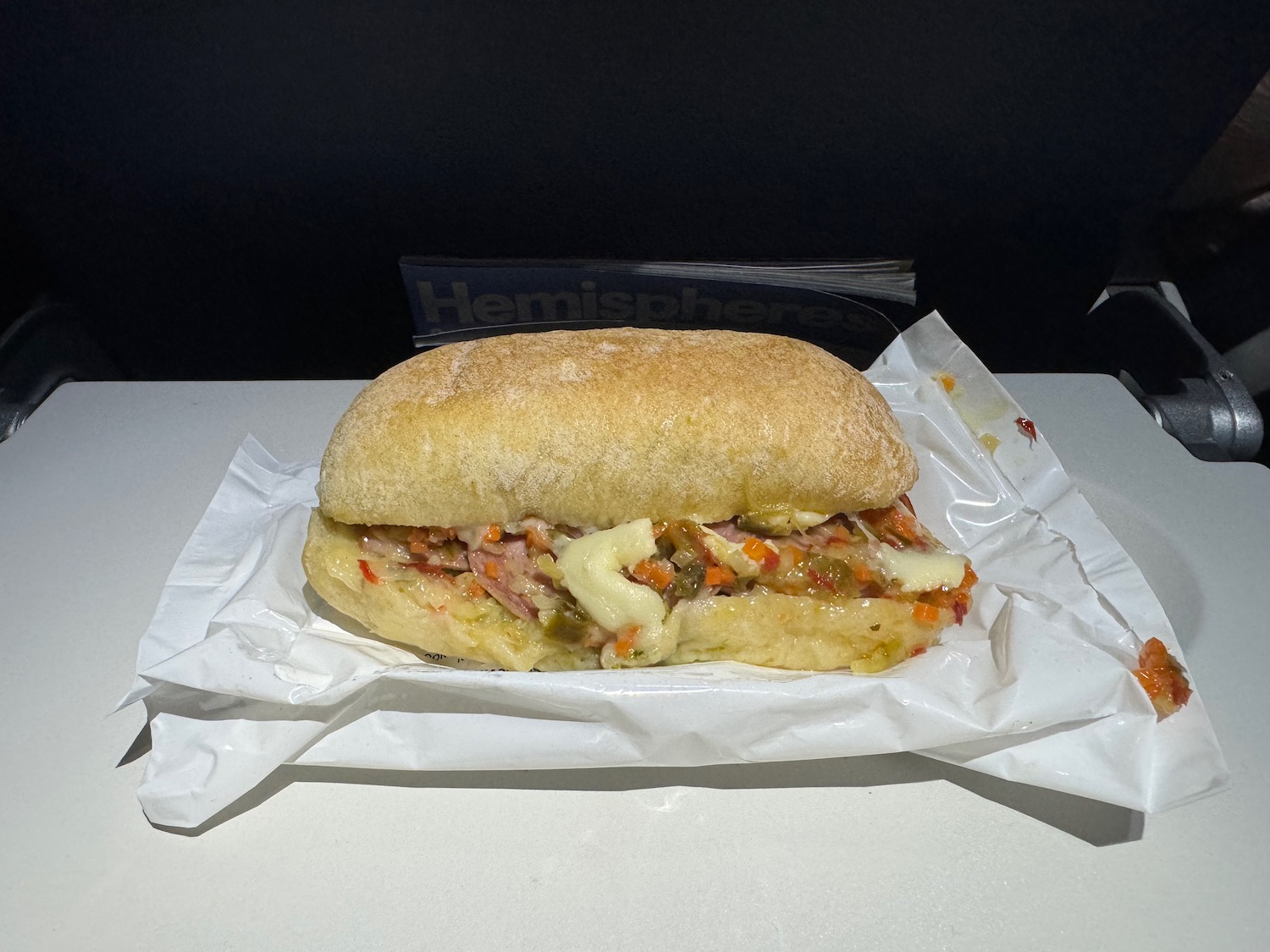 a sandwich on a white paper