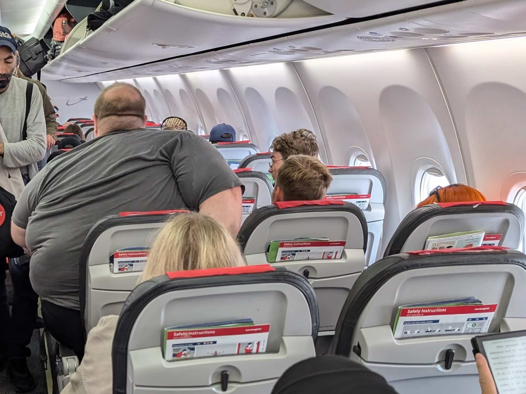 a group of people sitting in an airplane