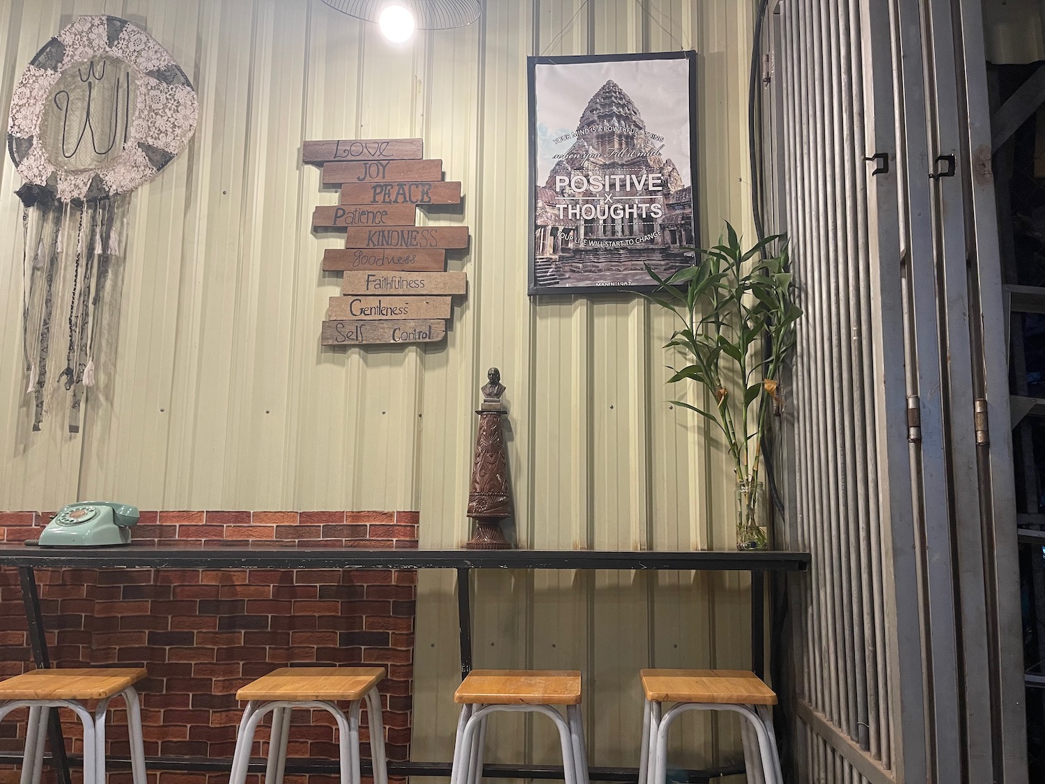 a room with stools and a poster on the wall