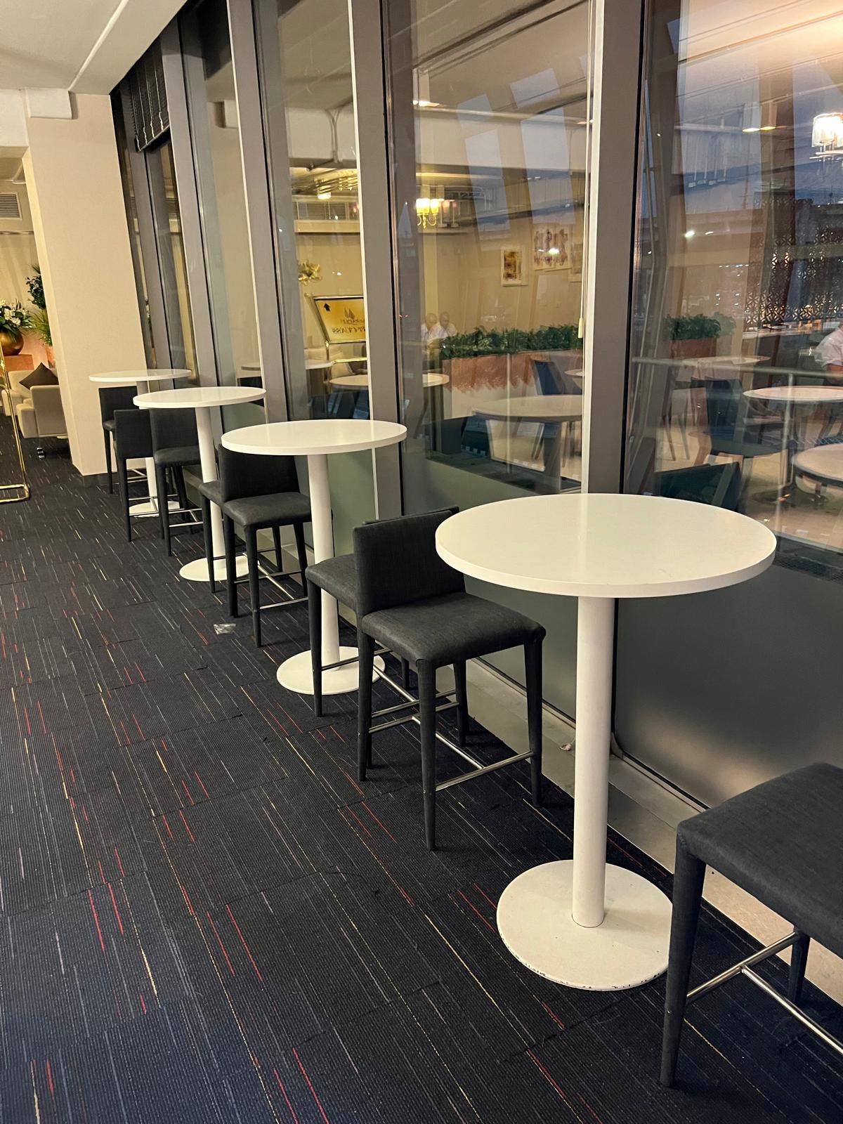 a row of tables and chairs in a room