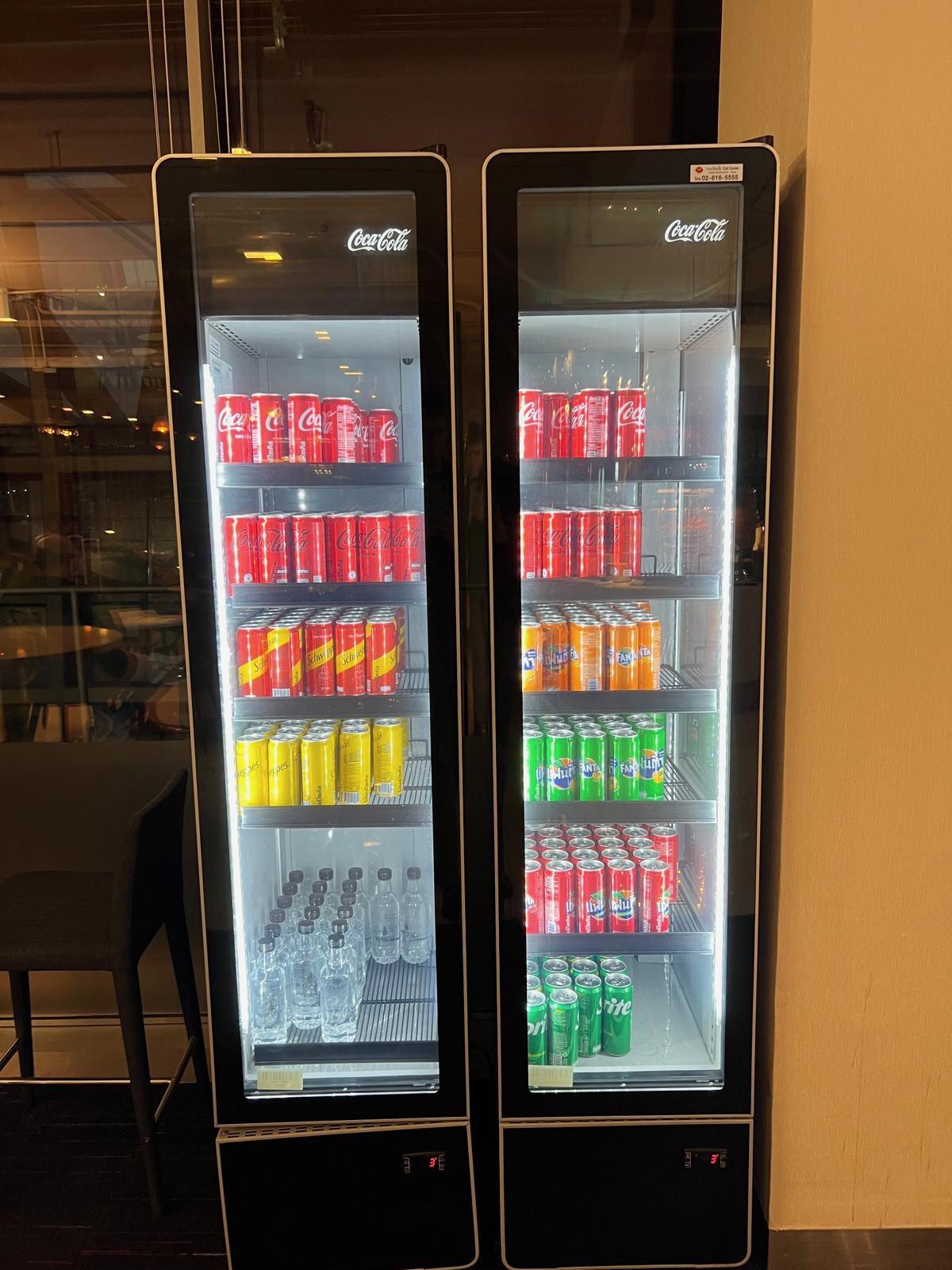 a two refrigerators with drinks and cans