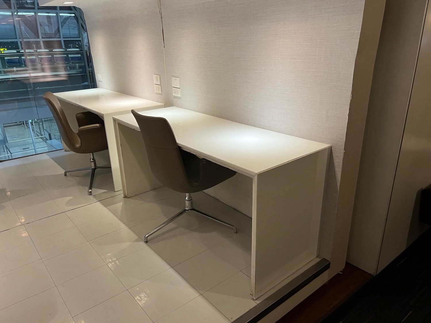 a white desks and chairs in a room