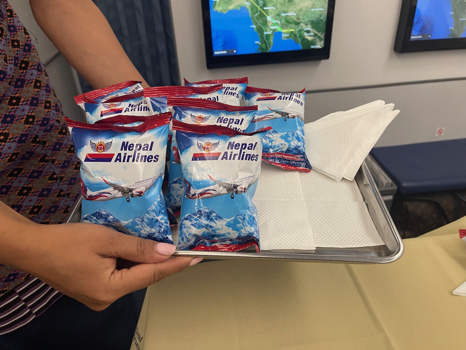 a person holding a tray of food