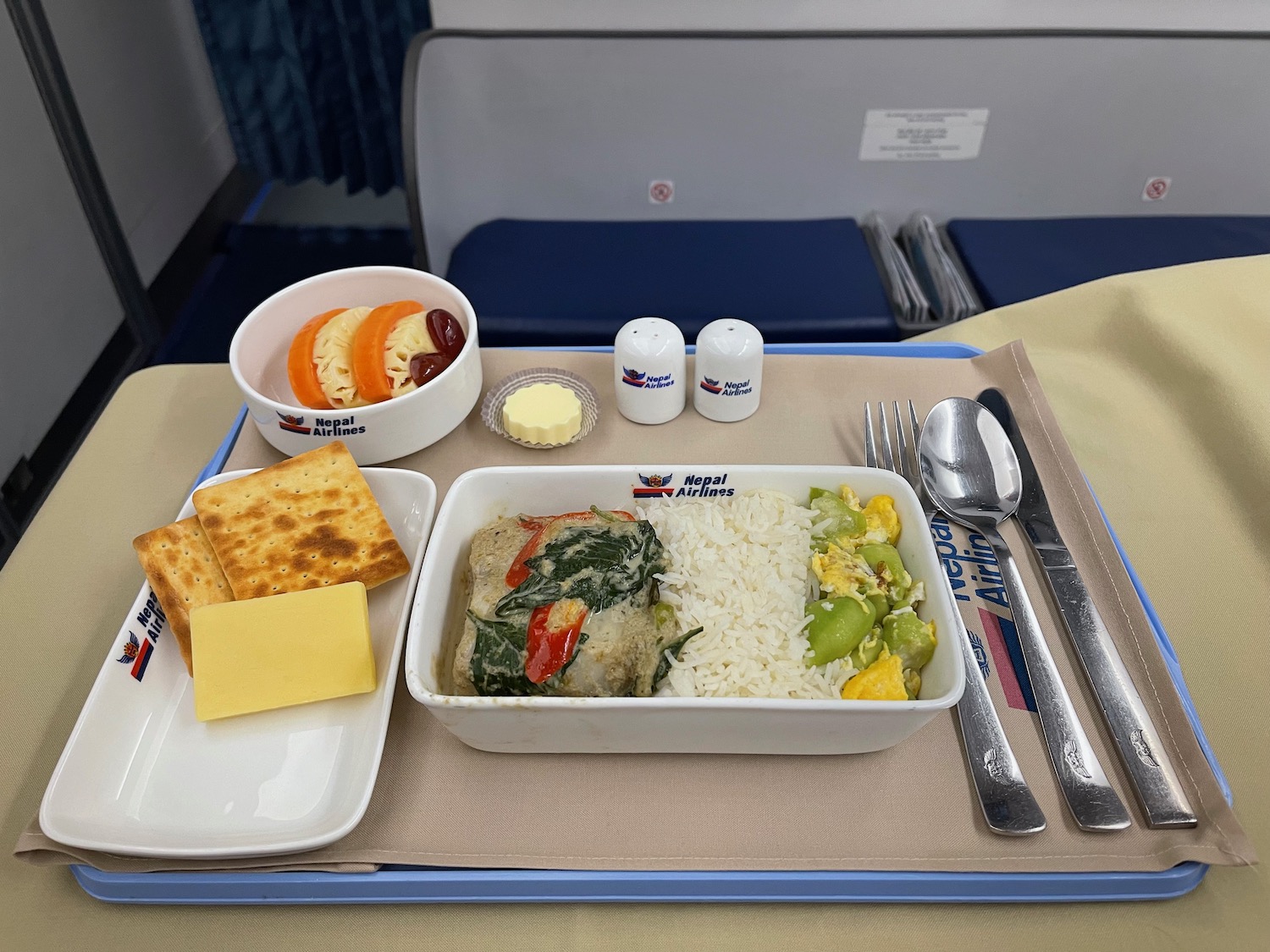 a tray with food and utensils on a table