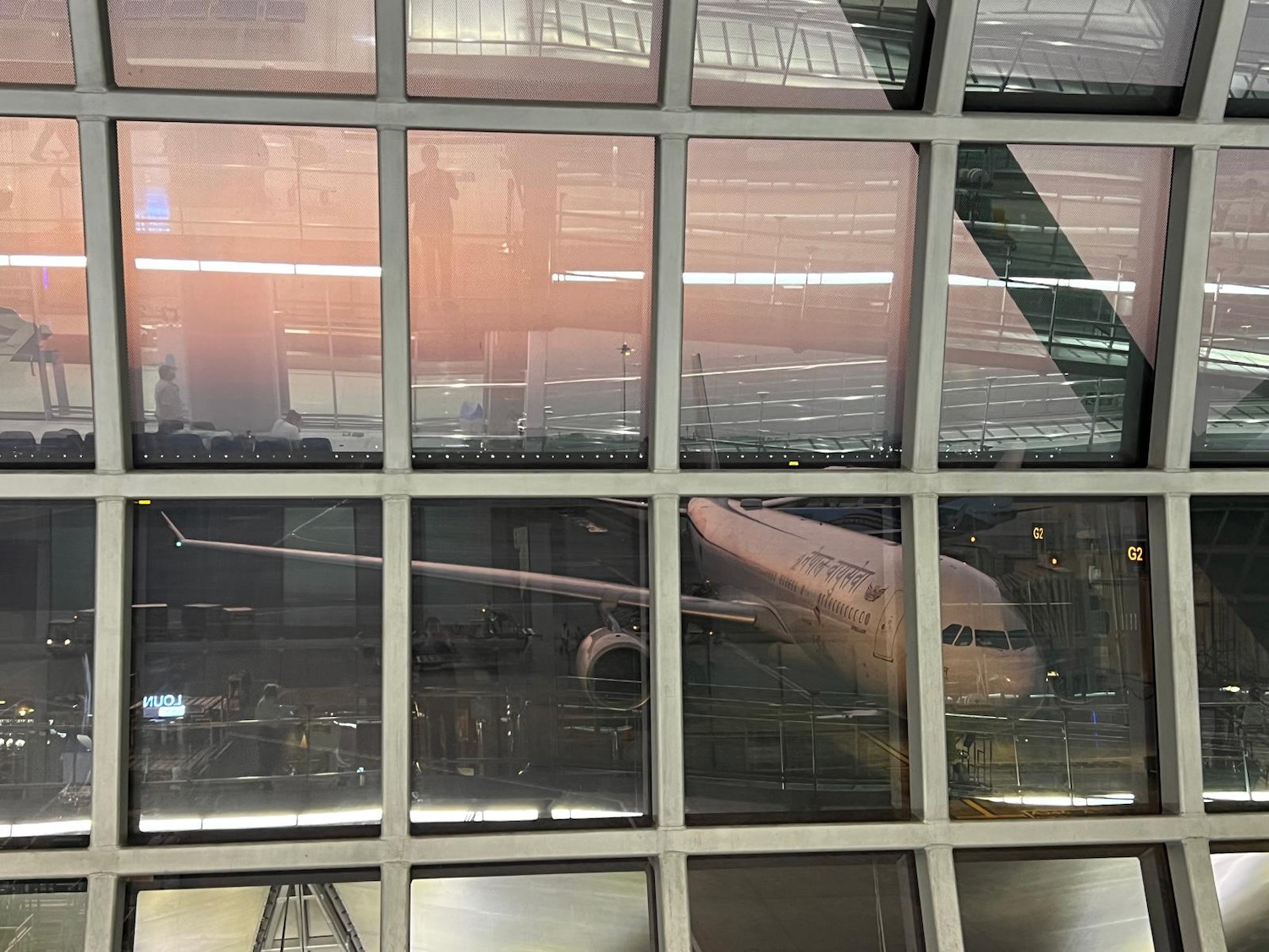 a window of an airport with a plane in it