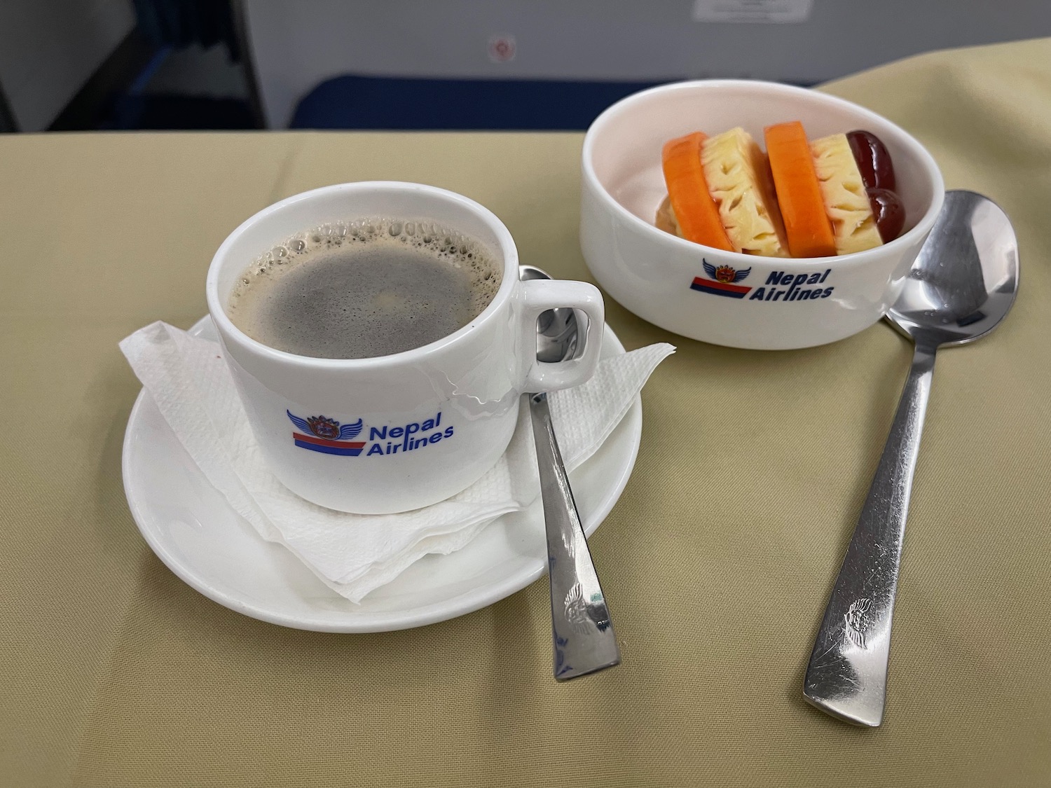 a cup of coffee and a bowl of fruit