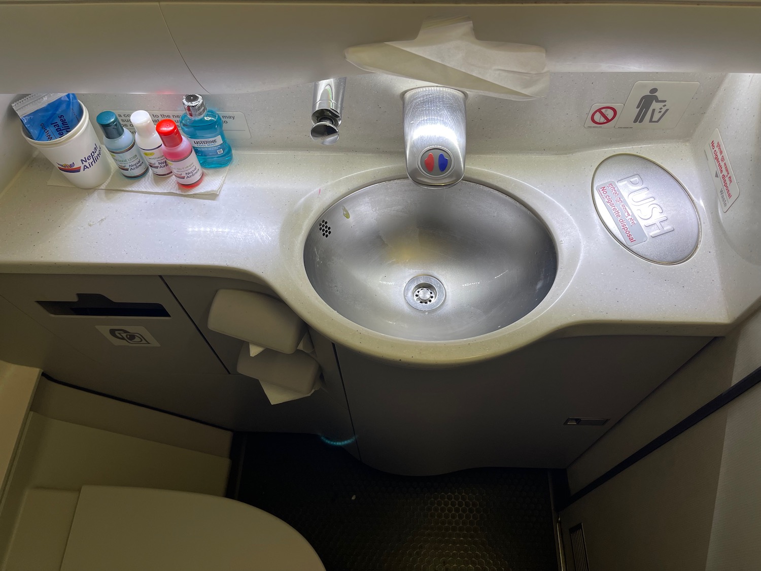 a sink with a few bottles of shampoo on it