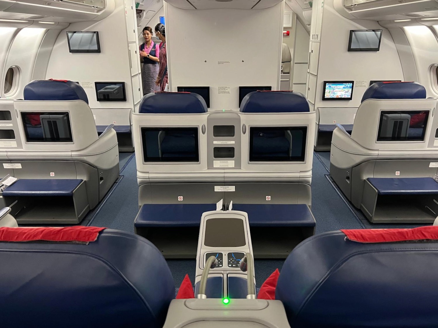 a group of people standing in the back of an airplane