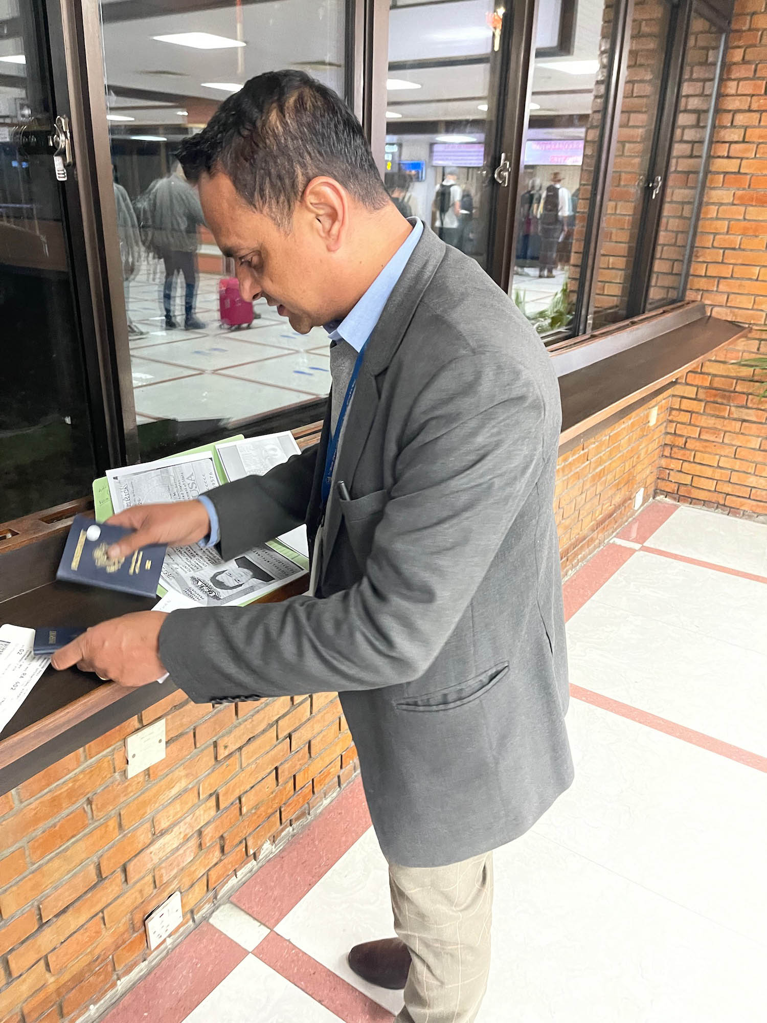 a man holding a passport and a book