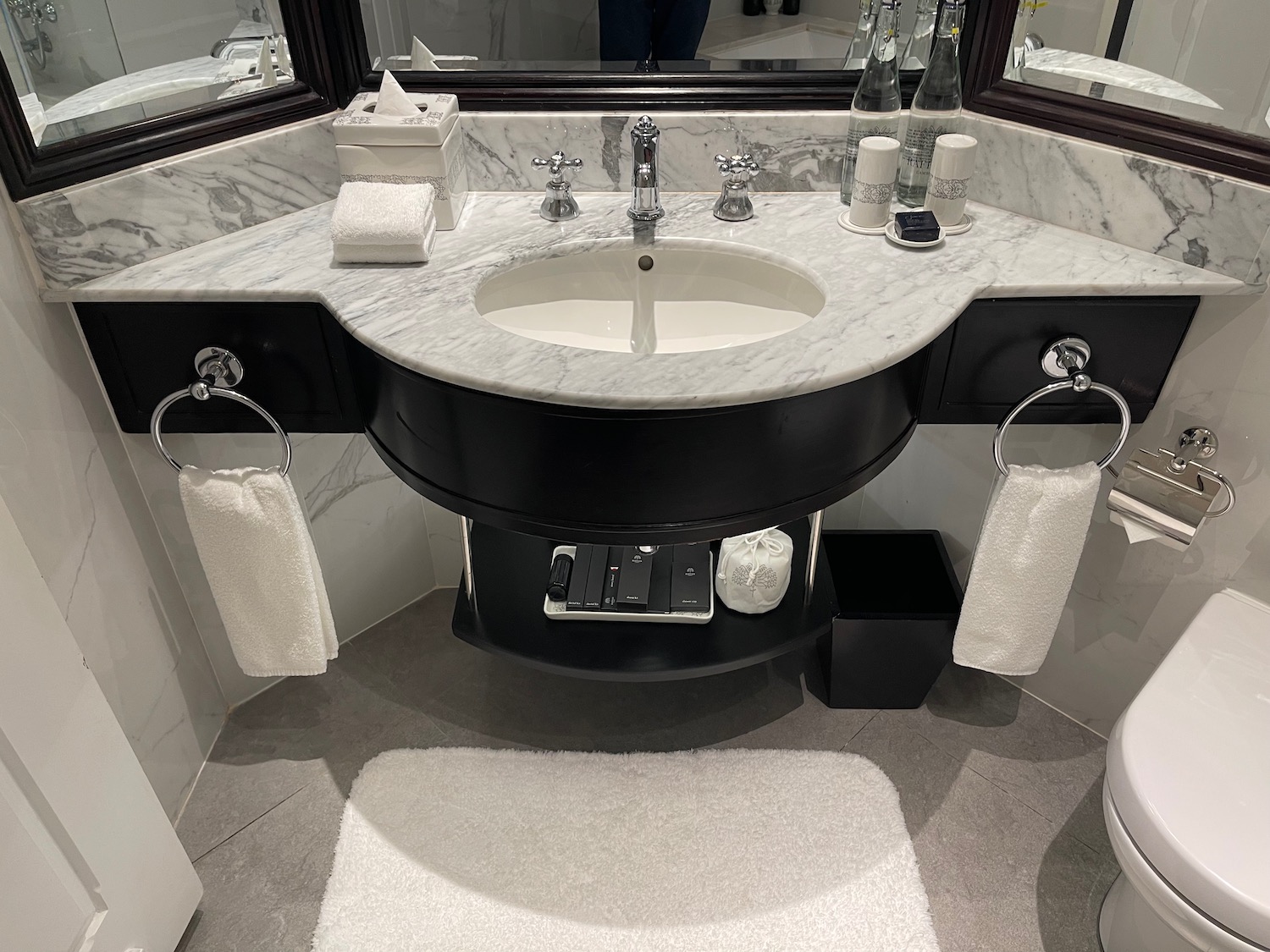 a bathroom with a marble sink and a mirror