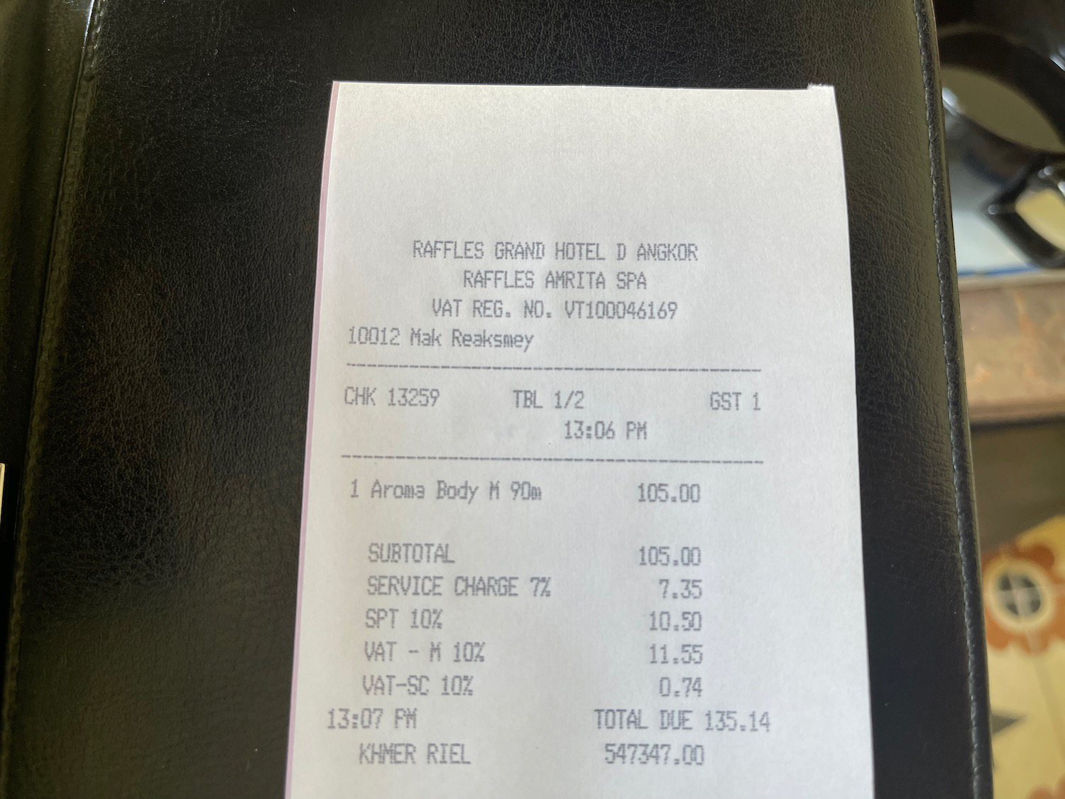 a receipt on a leather surface