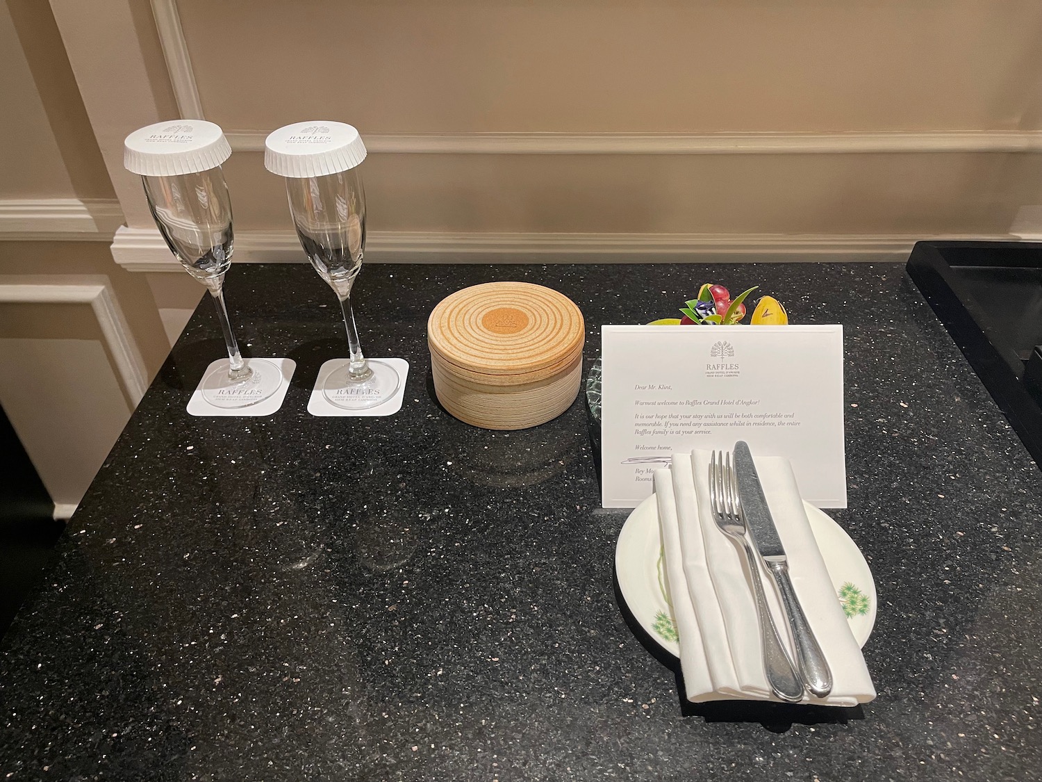 a table with a plate and glasses and a card