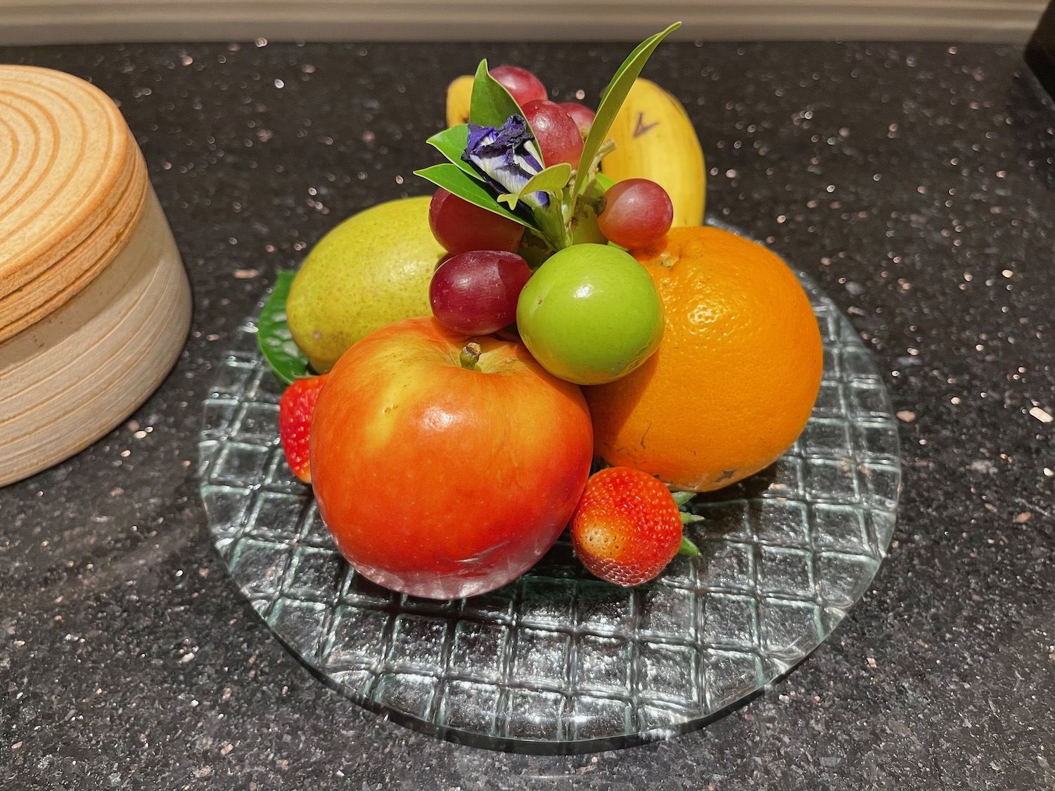 a glass plate with various fruits on it