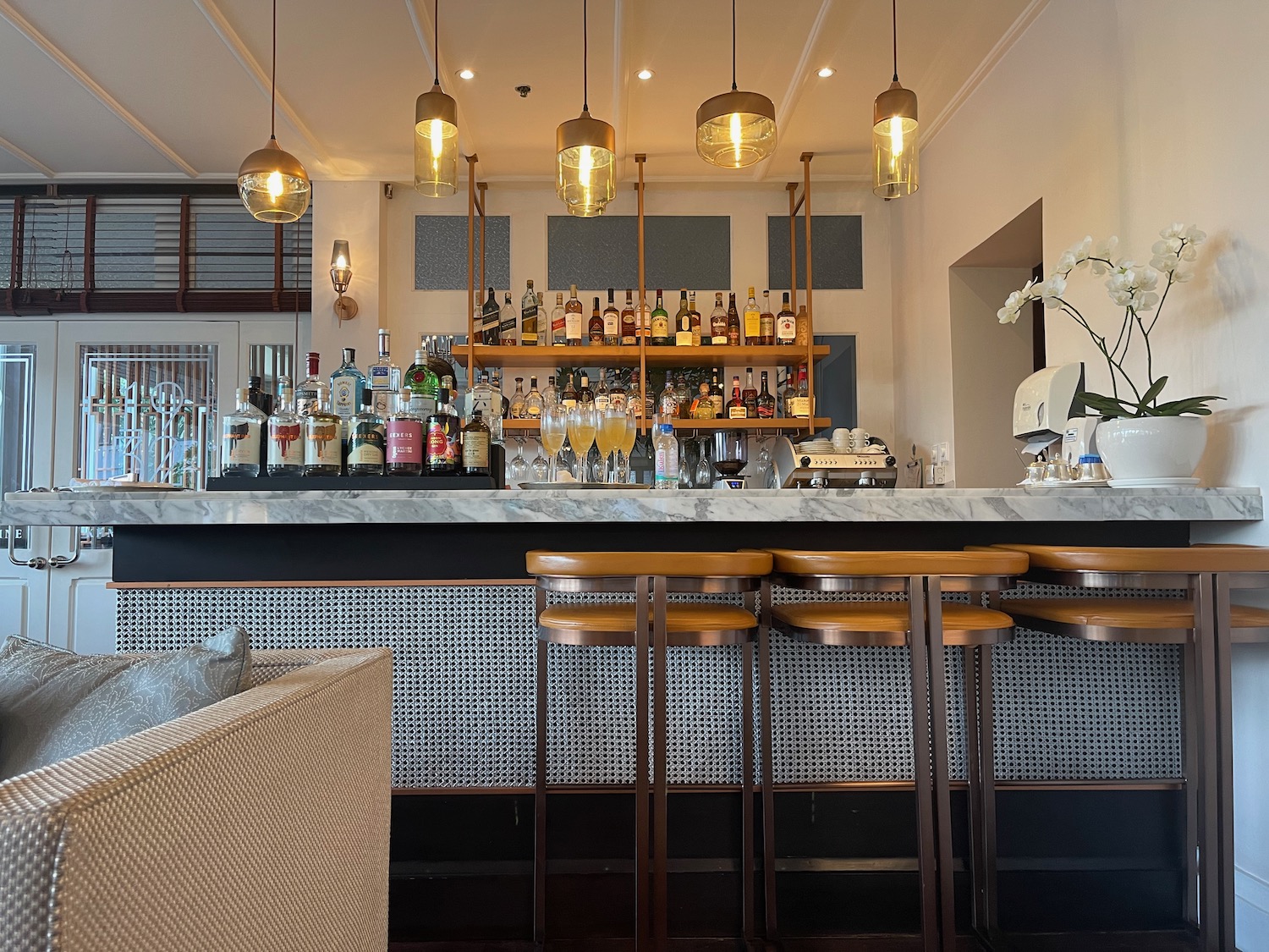 a bar with bottles of alcohol and a counter