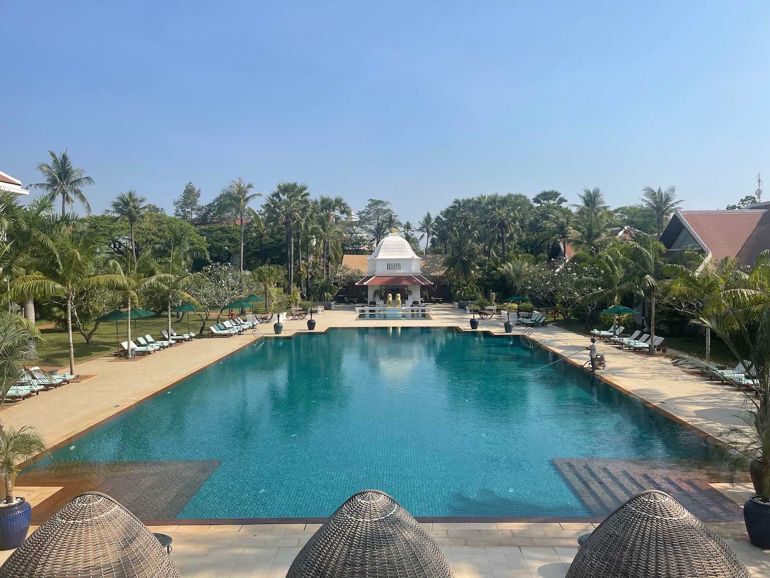 a pool with a building and trees