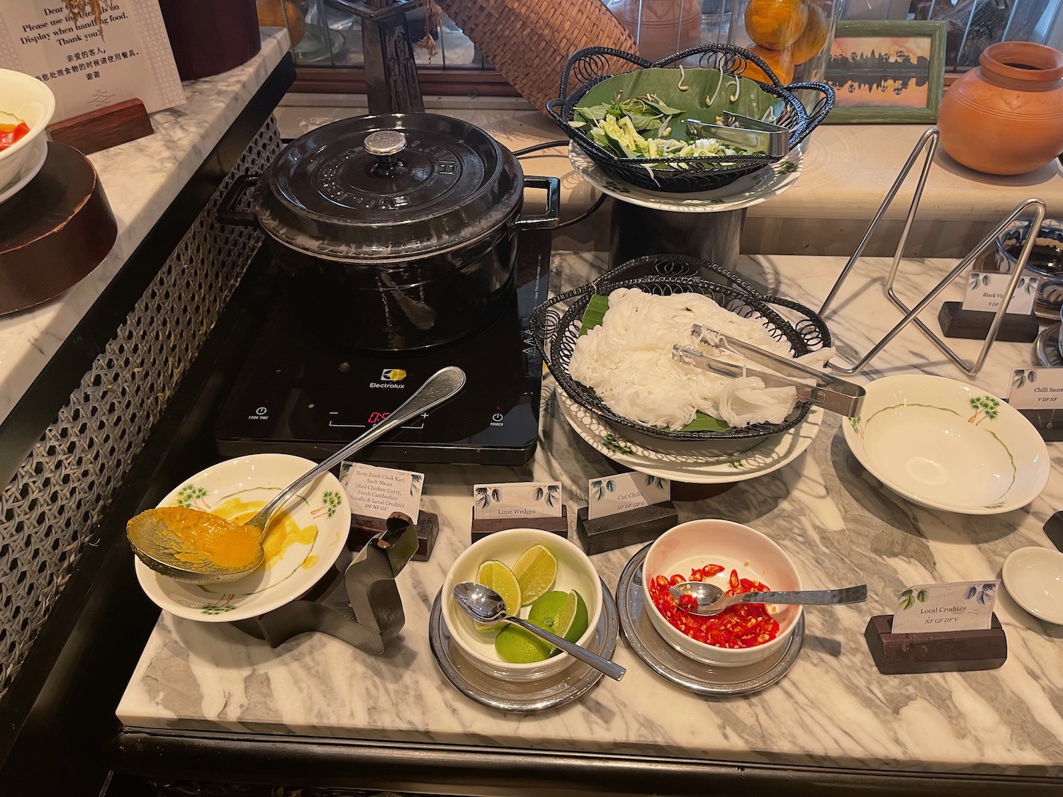 a table with bowls of food and utensils