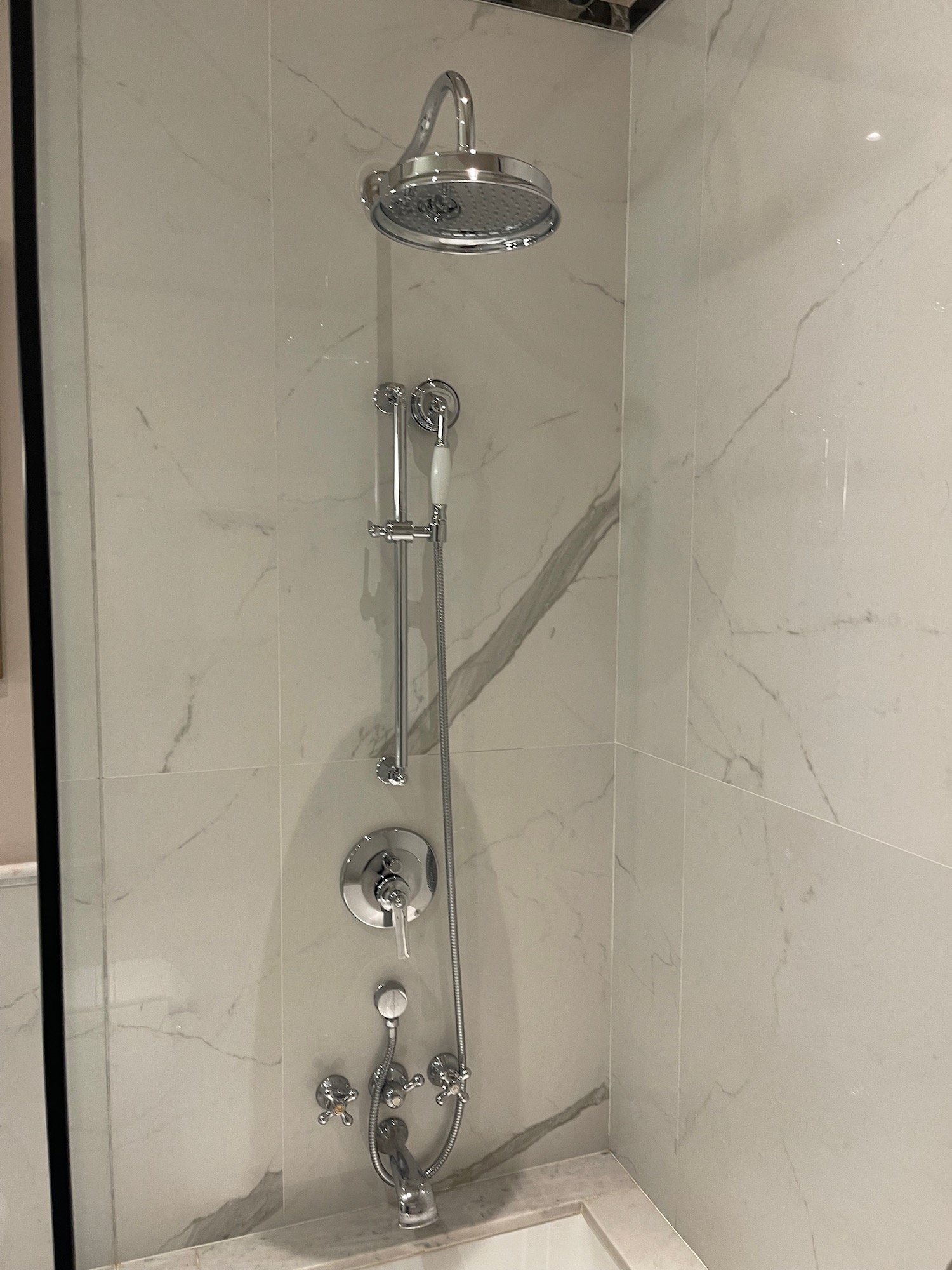 a shower head and faucet in a bathroom