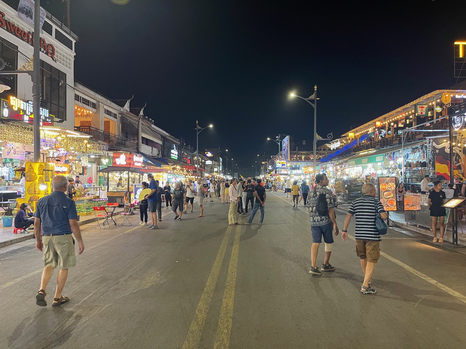 a crowd of people walking on a street