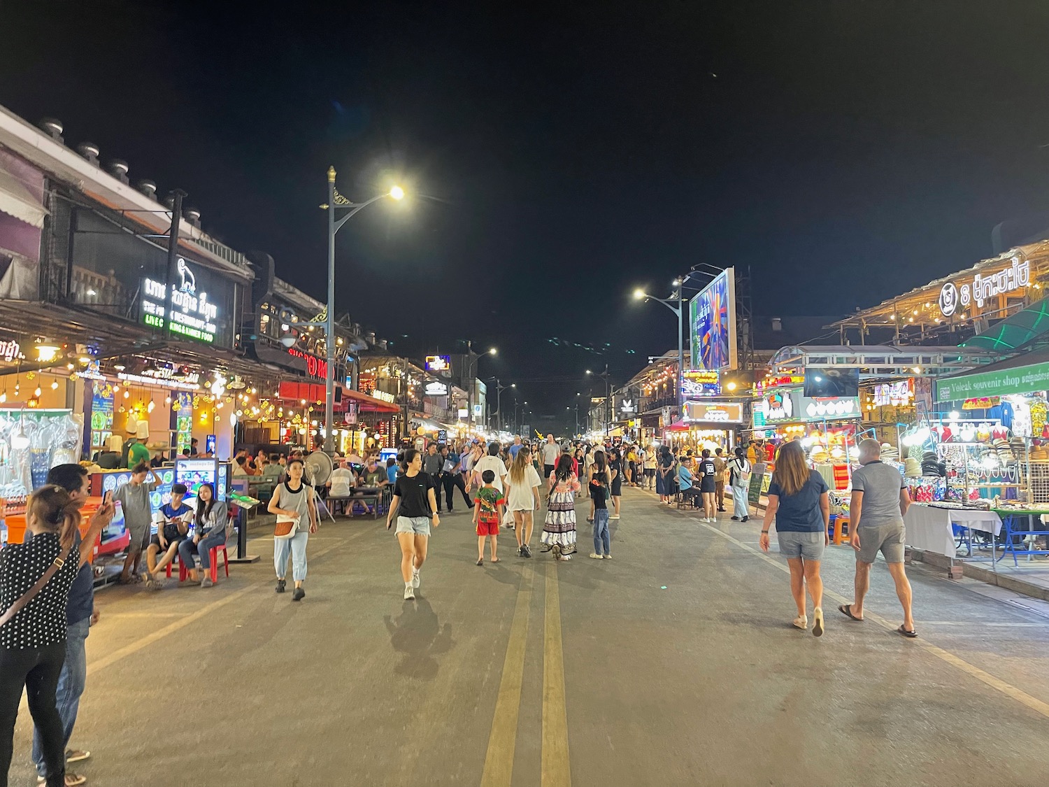 a crowd of people walking down a street