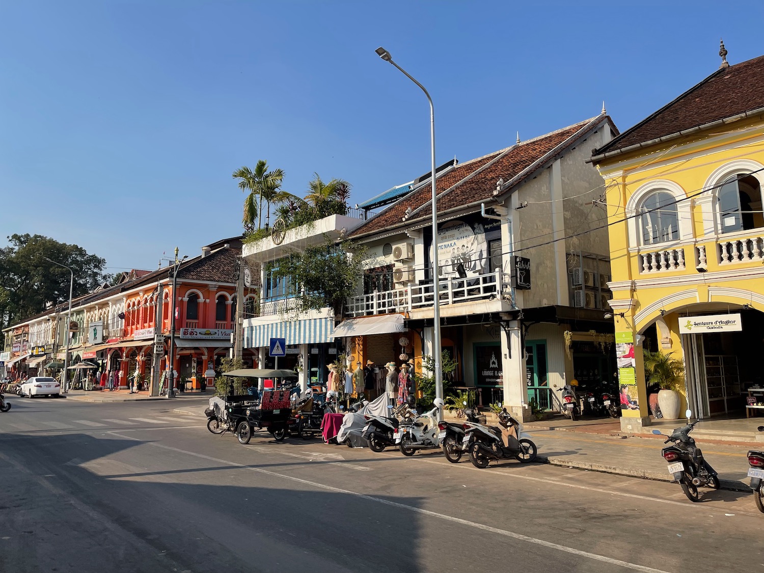 a street with buildings and motorcycles