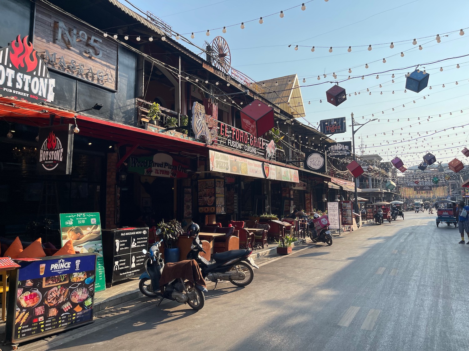 a street with motorcycles and signs