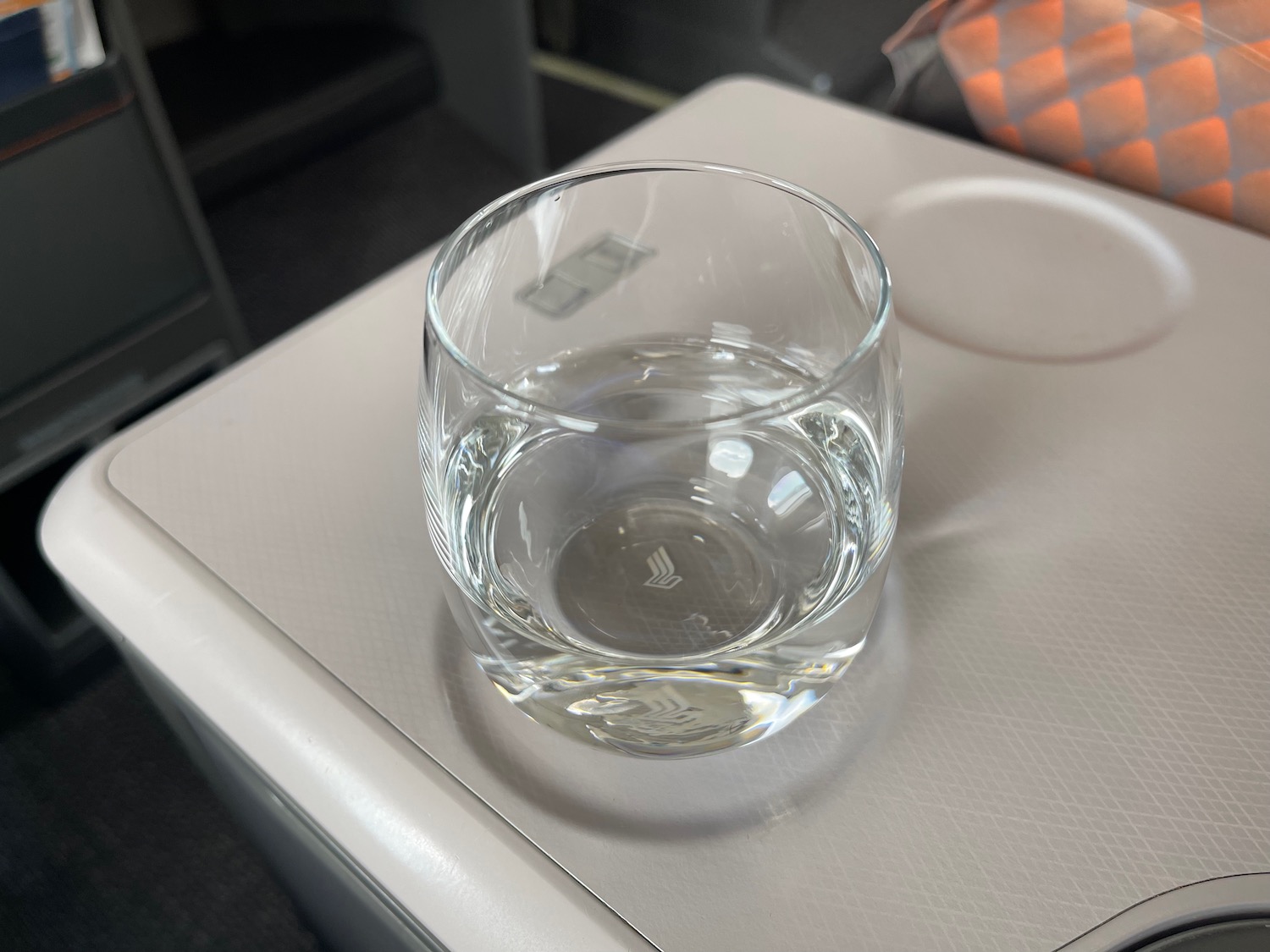 a glass of water on a tray