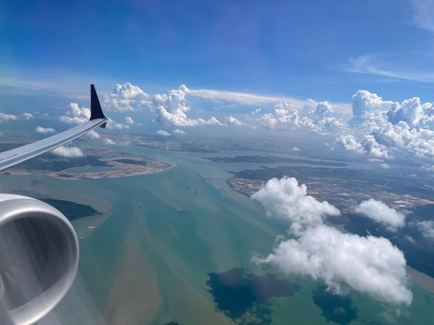 an airplane wing and a body of water