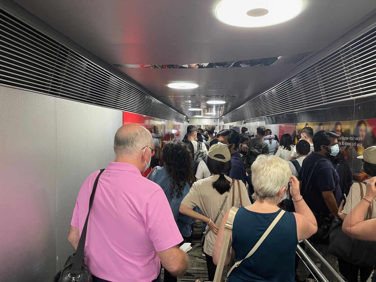 a group of people walking in a hallway