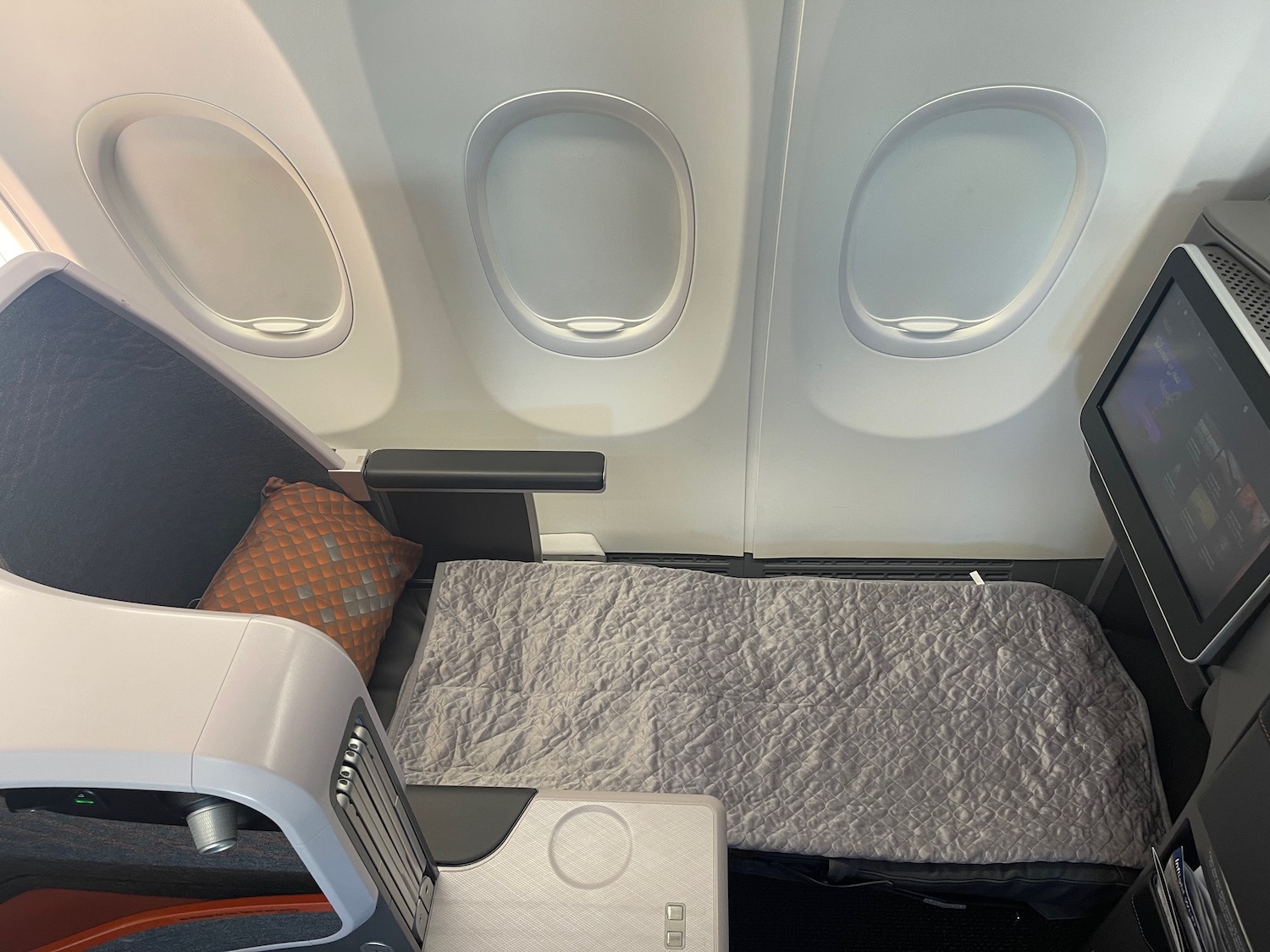 an airplane with a bed and a tv