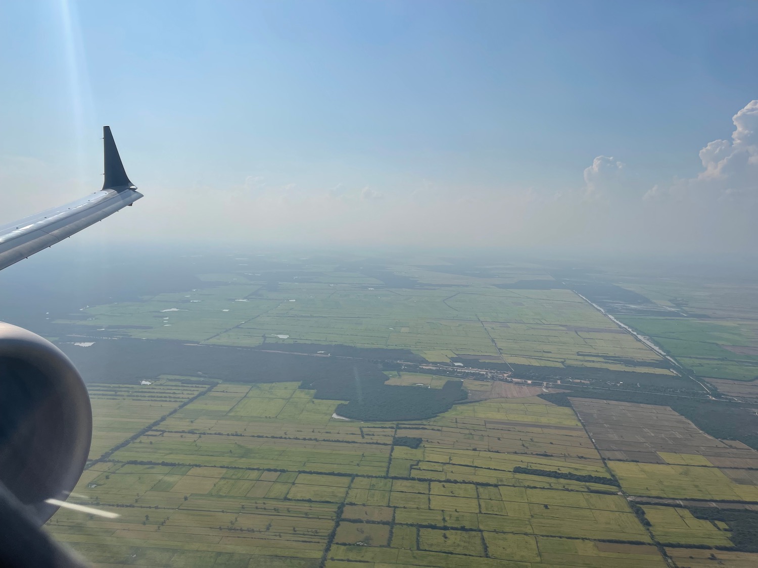 an airplane wing and a landscape