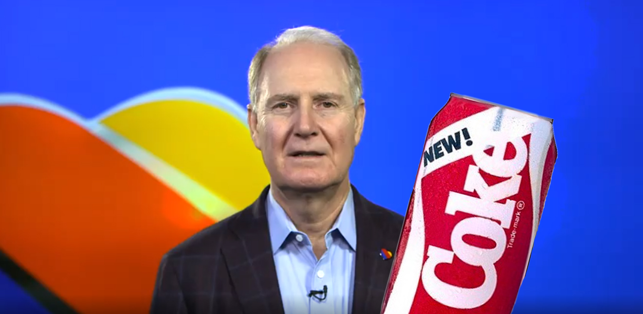 a man in a suit holding a soda