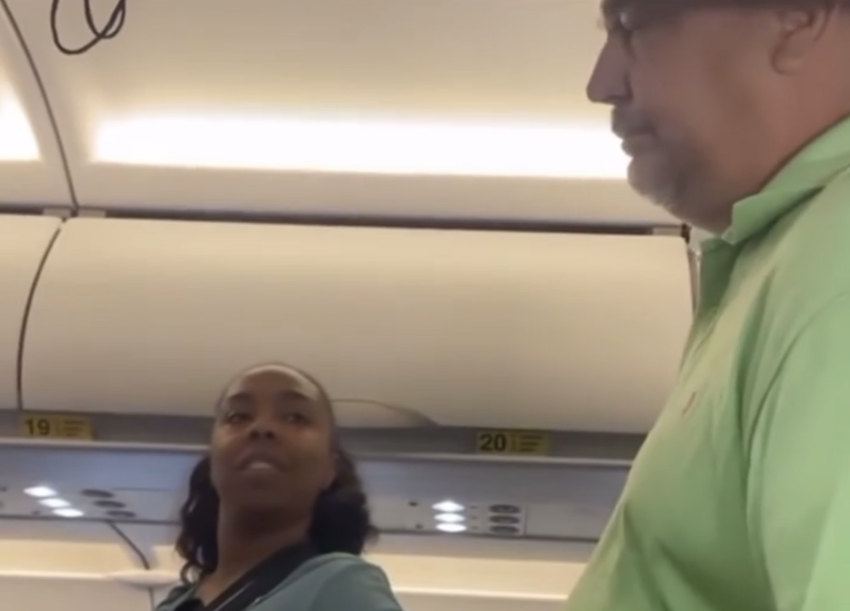 a man and woman standing in a plane