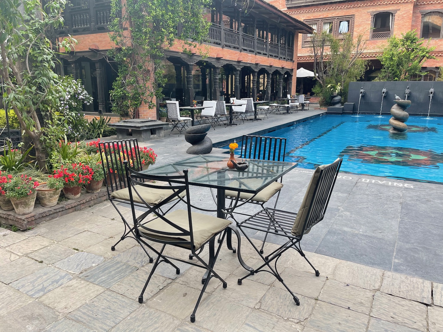 a table and chairs by a pool