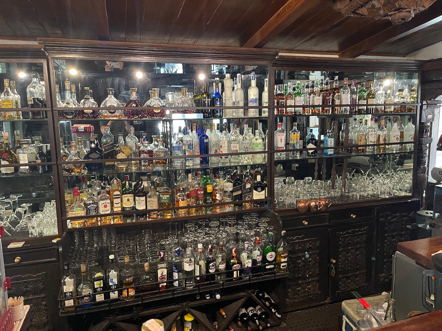 a glass shelves filled with bottles