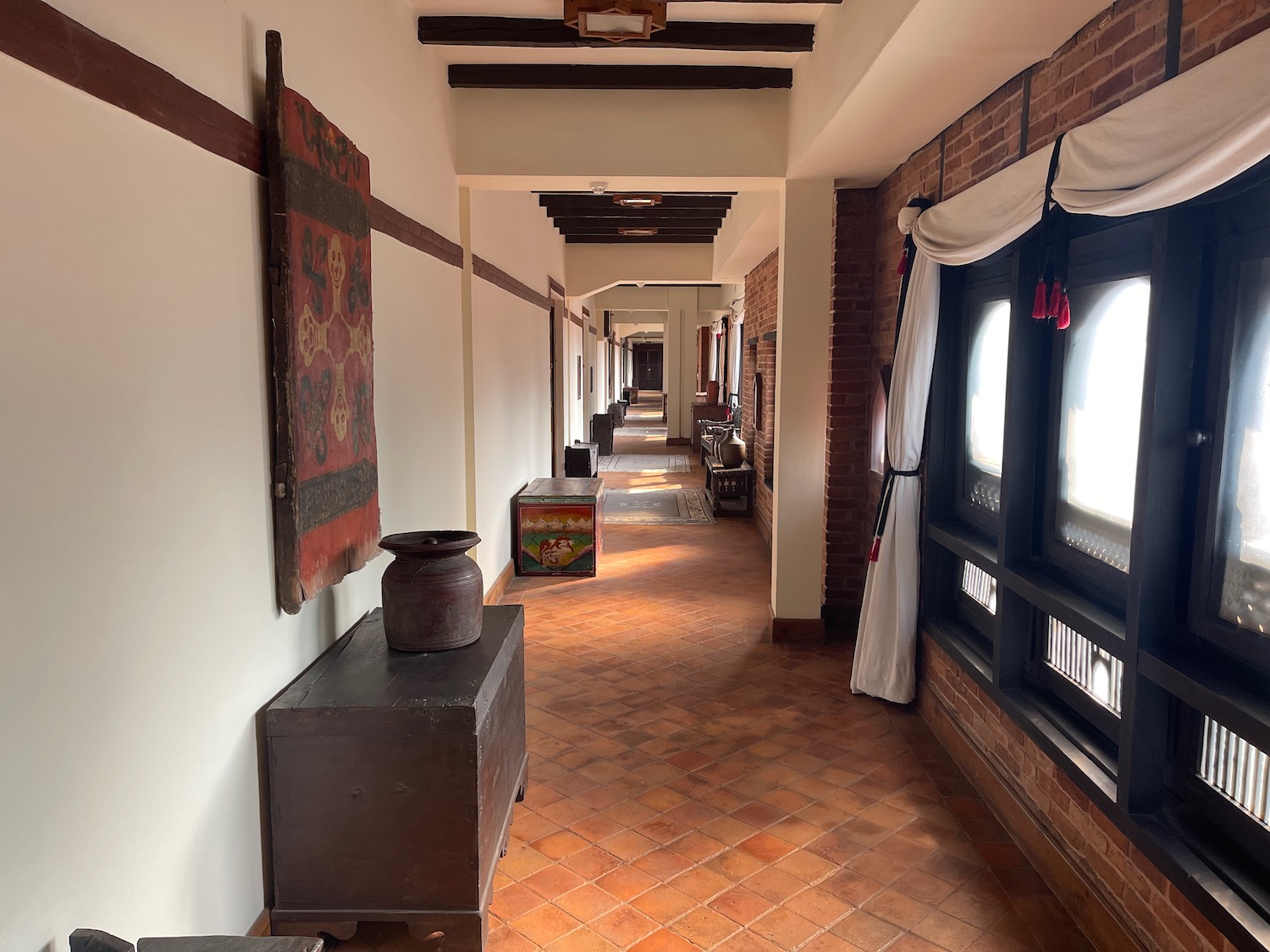 a hallway with a brick wall and a table