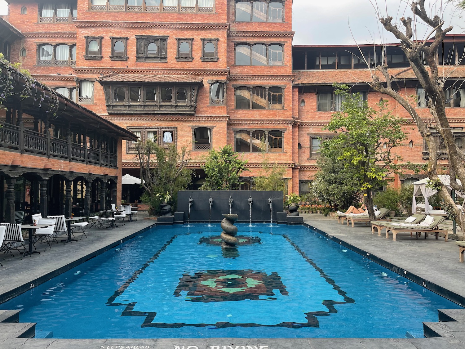 a pool with a fountain in the middle of a building