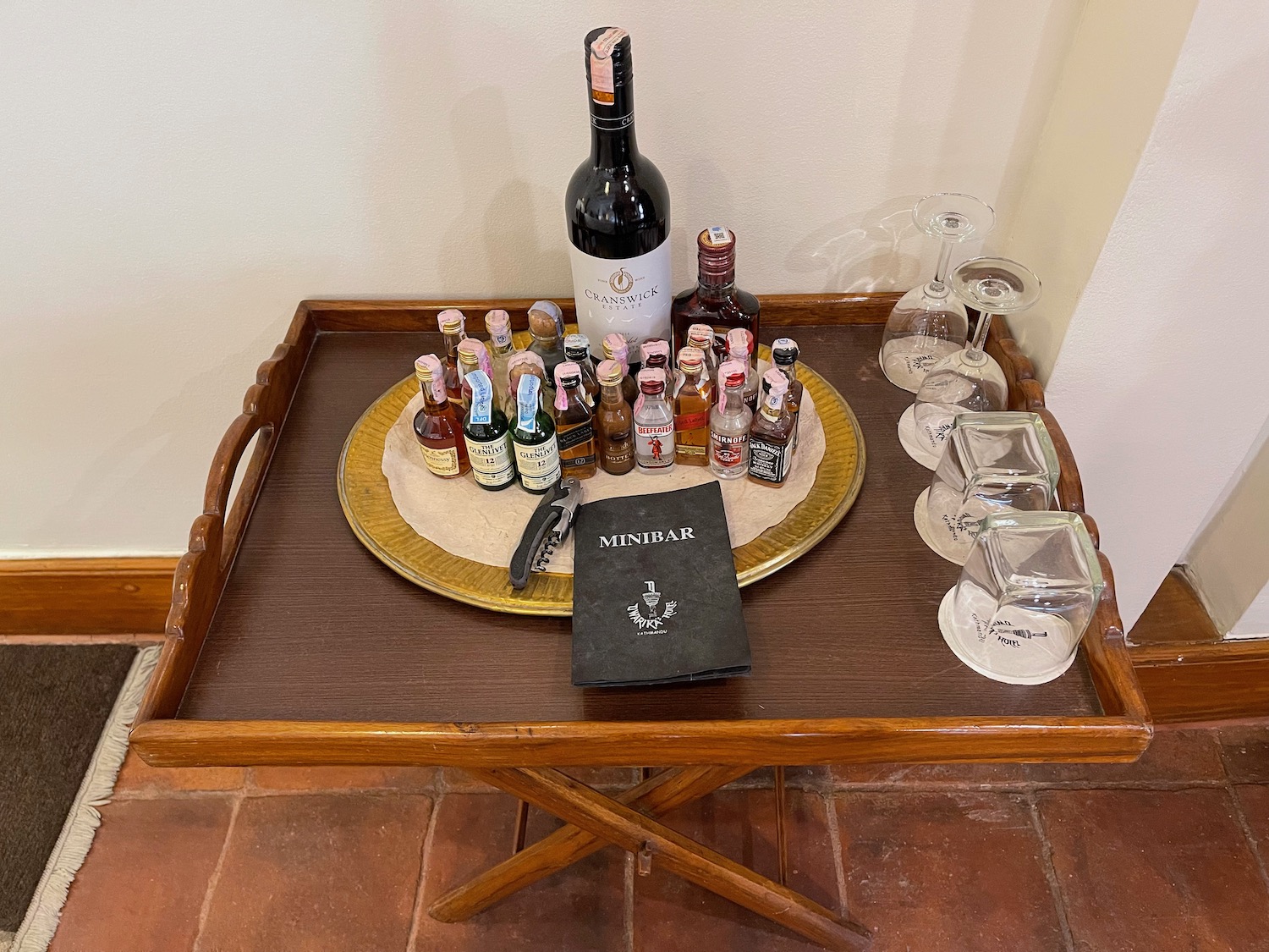 a tray with bottles and glasses on it