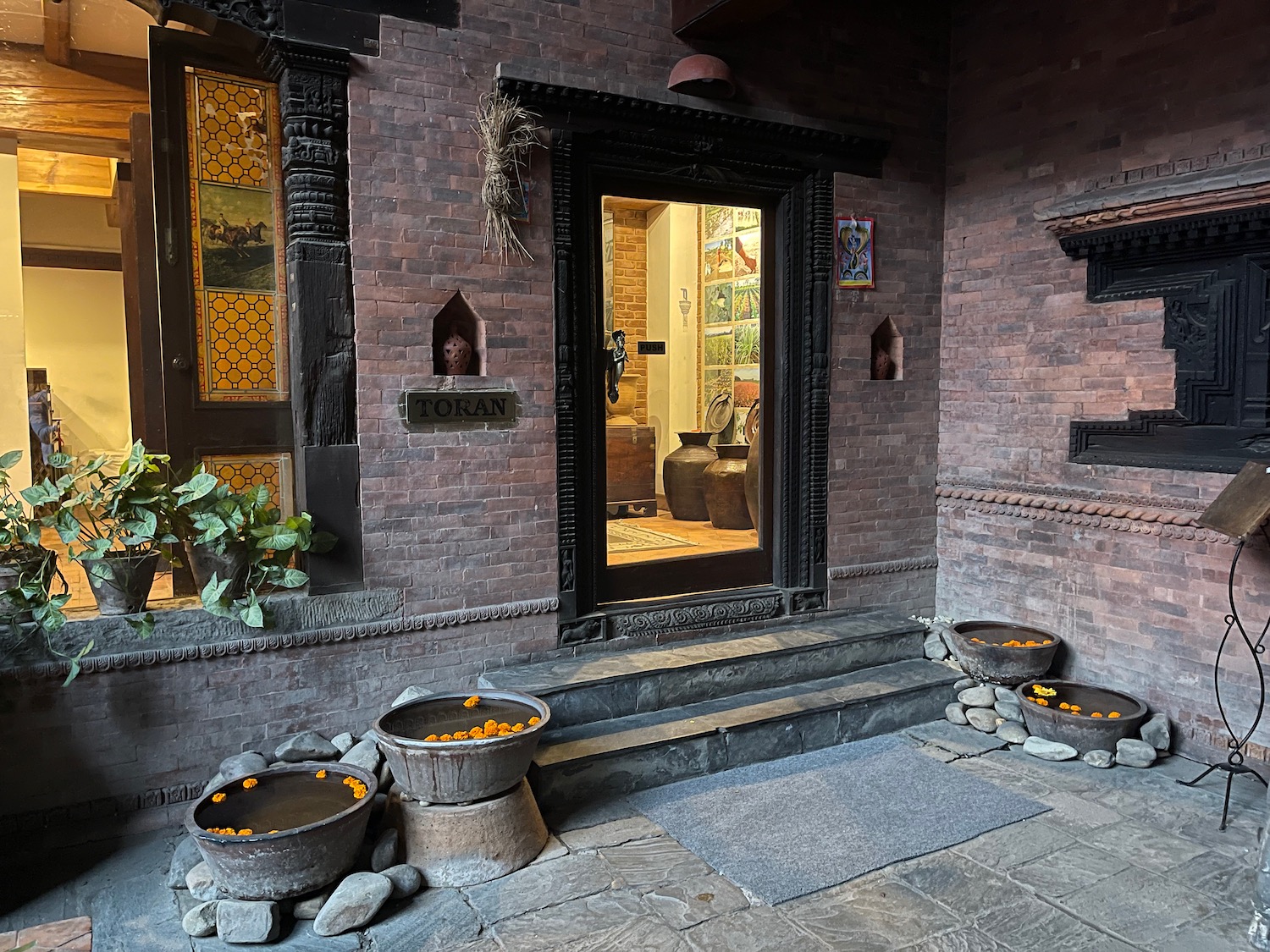 a brick building with a door and a glass door