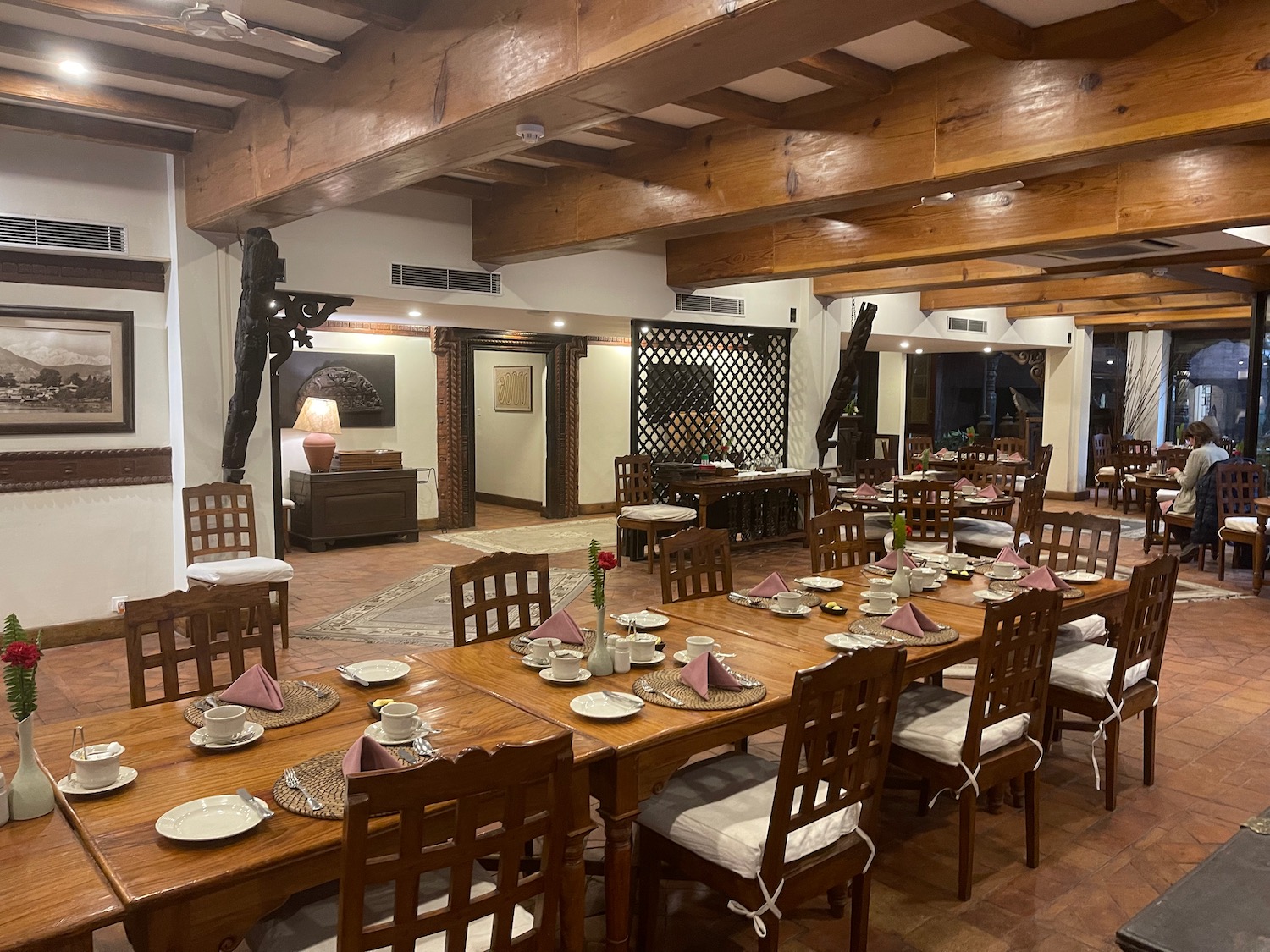 a large room with wooden beams and tables