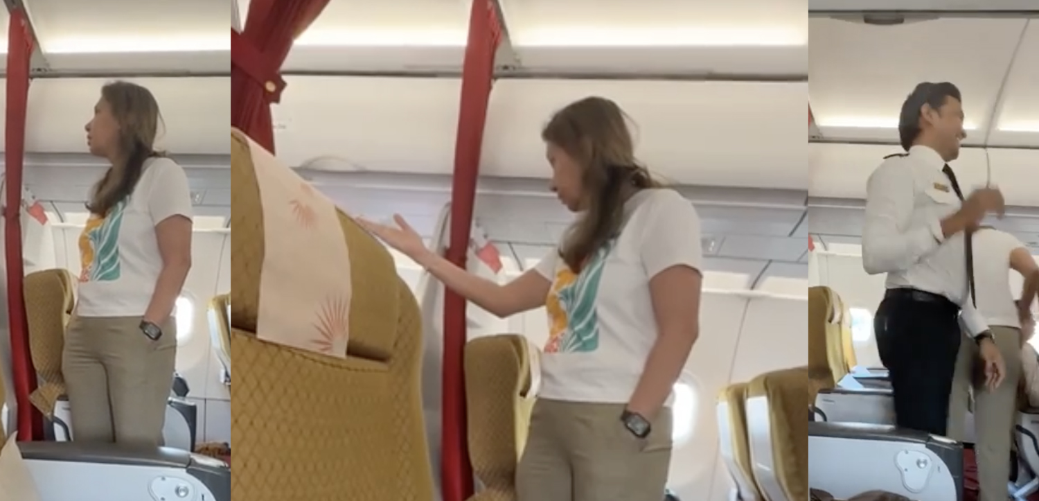 a woman standing in an airplane