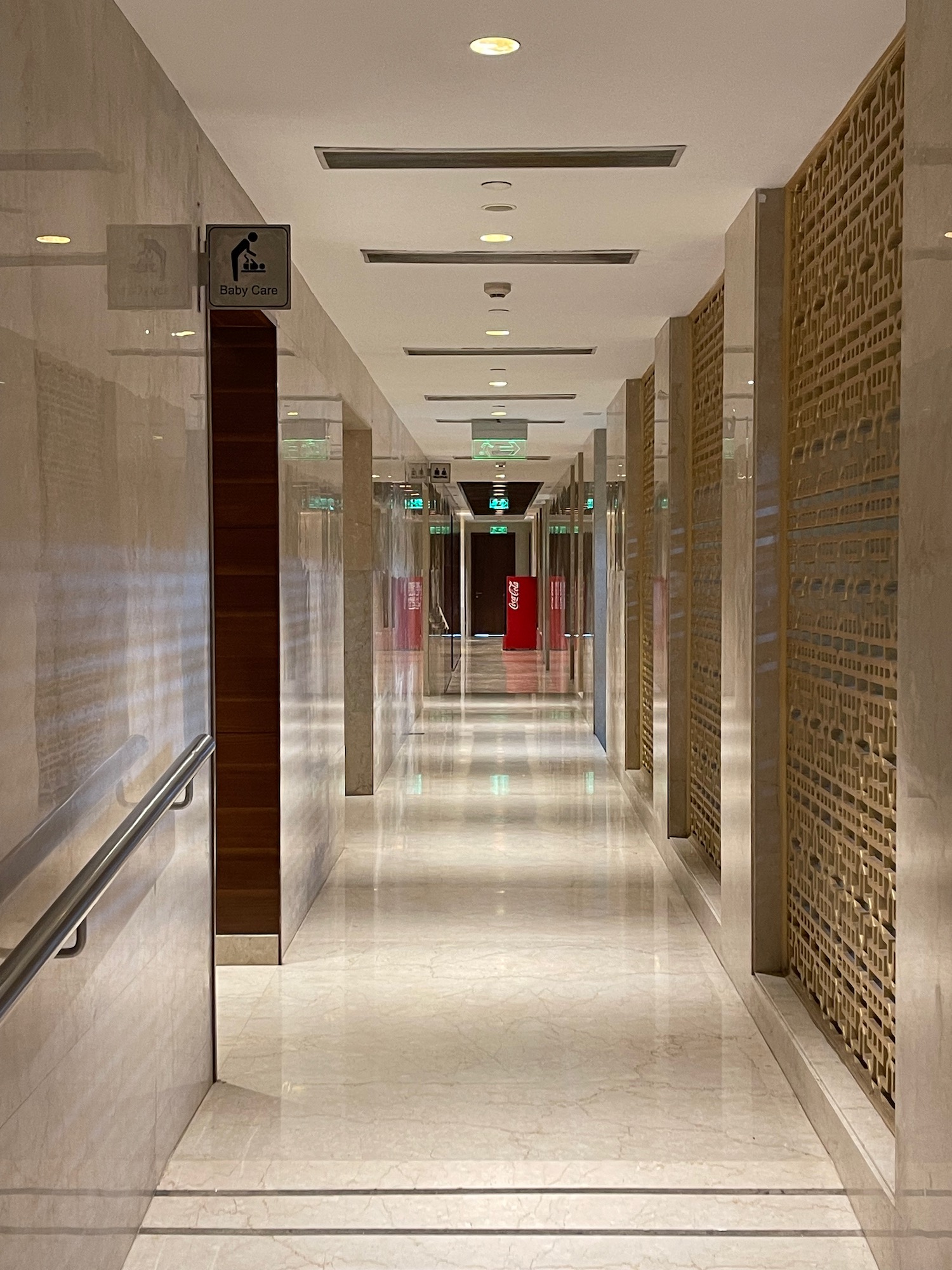 a hallway with a white tile floor