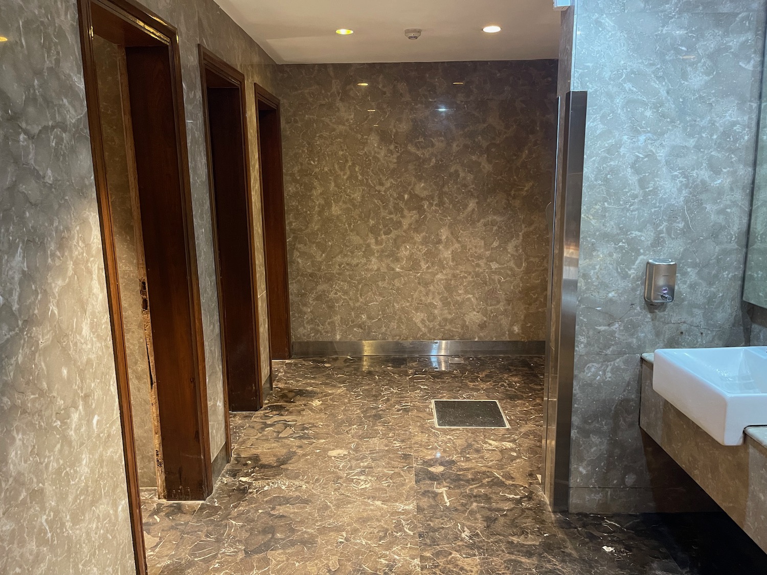 a bathroom with marble walls and a sink