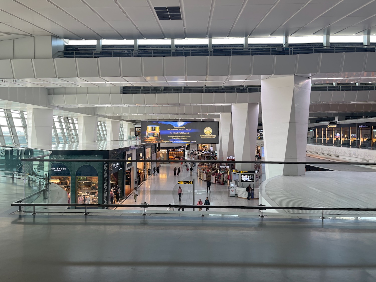 a large white building with many people walking around