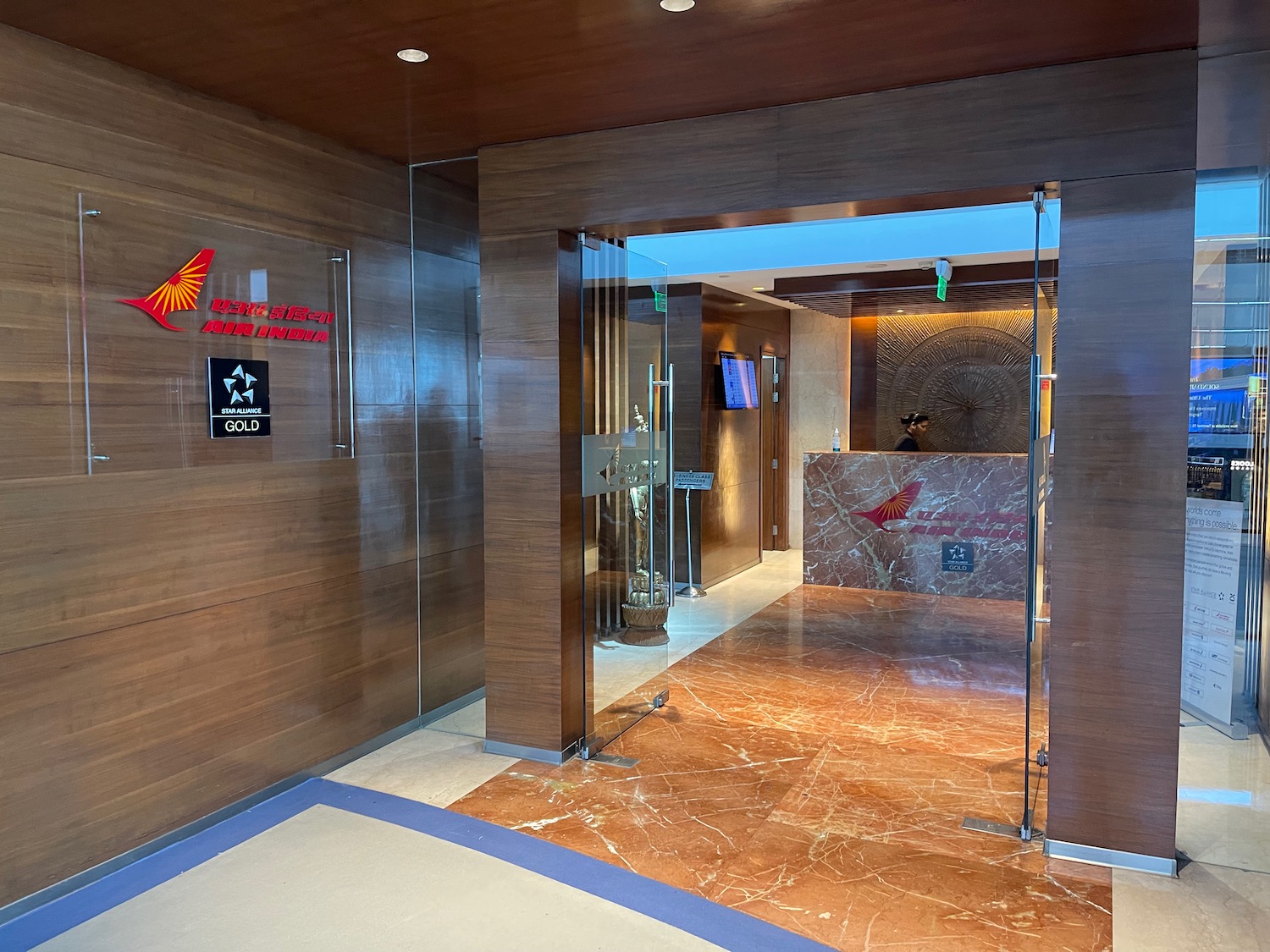 a lobby with glass doors and a reception desk