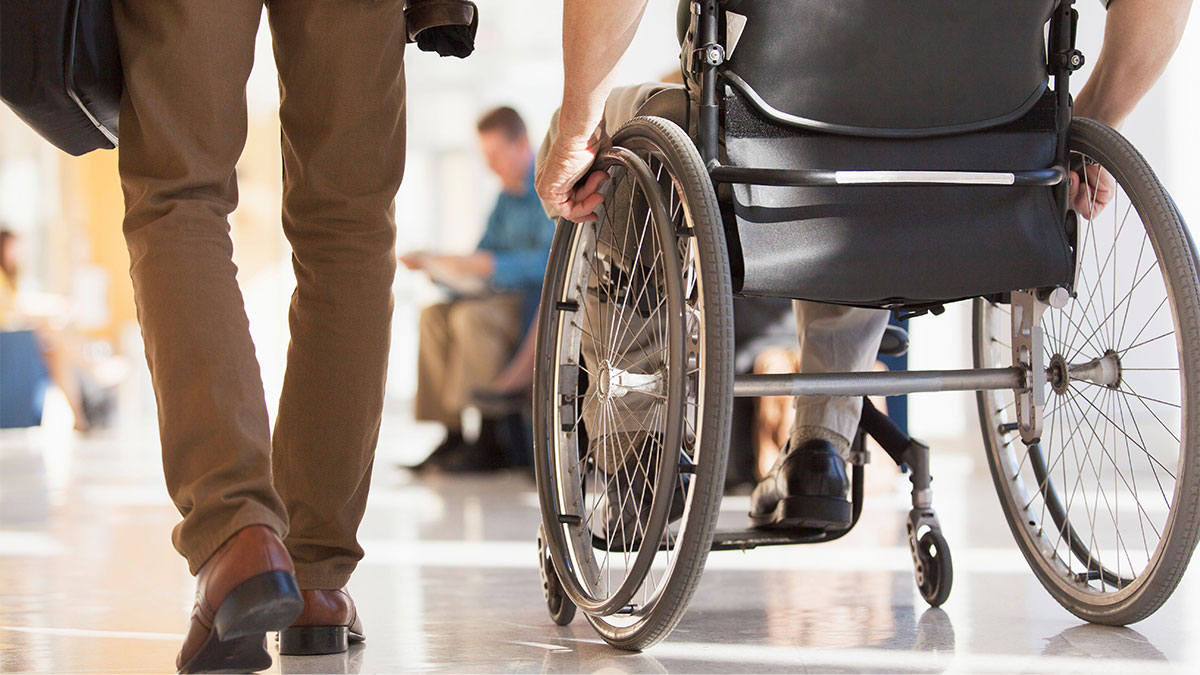 a man pushing a wheelchair