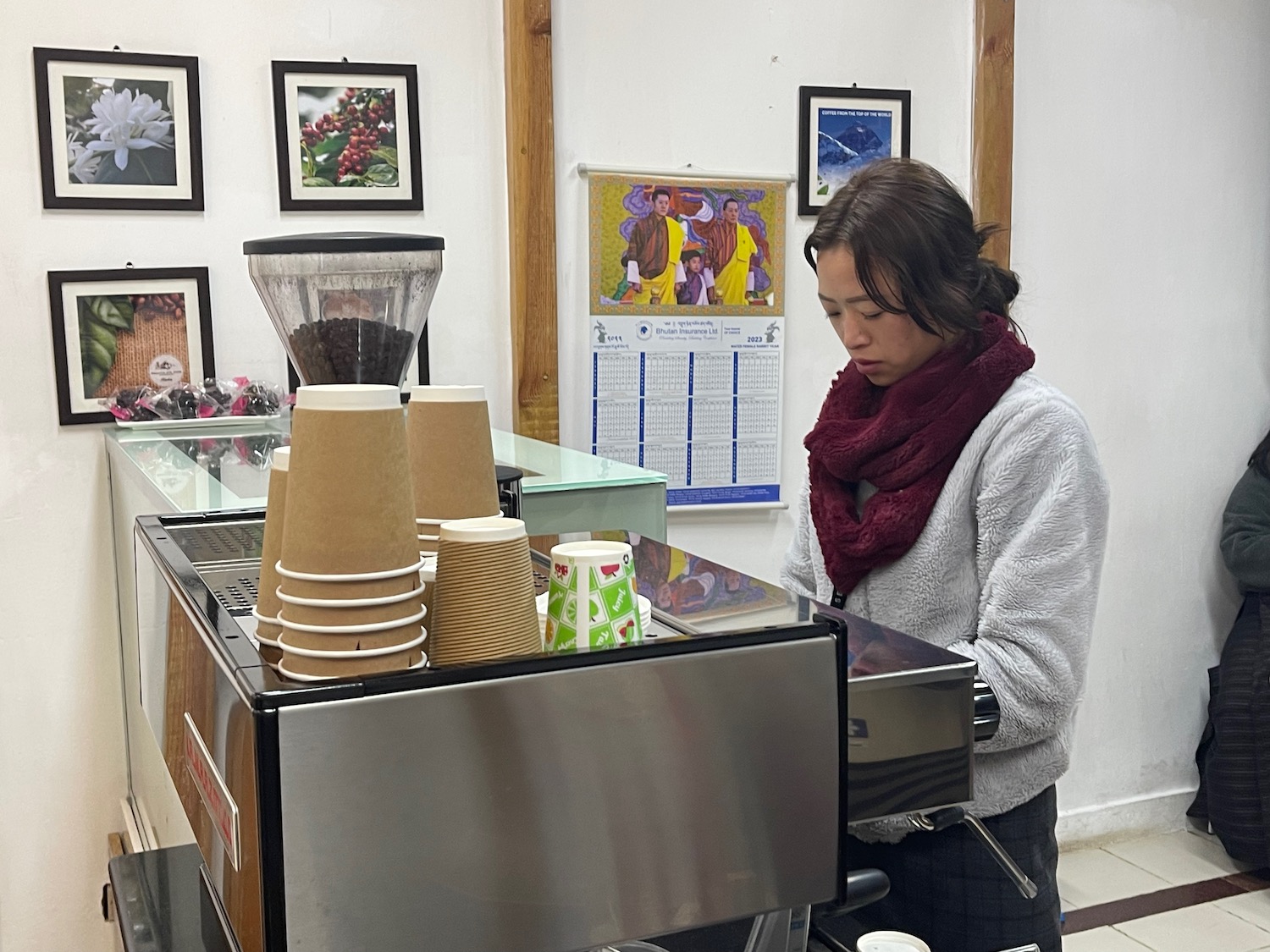 a woman standing behind a machine