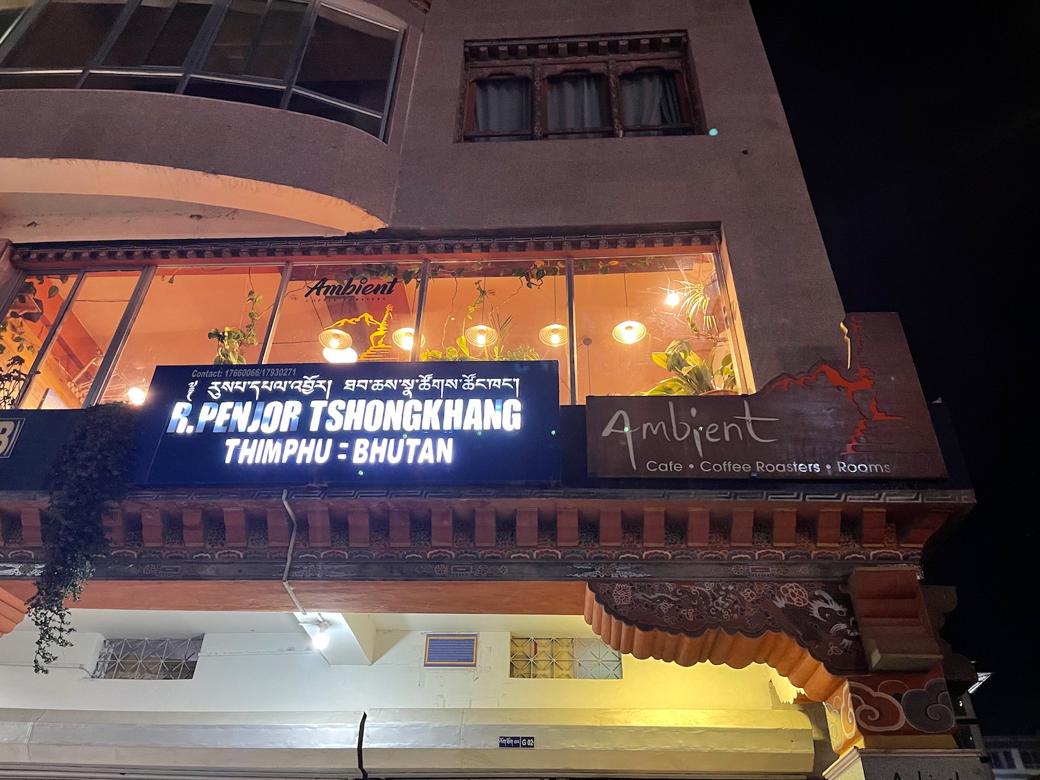 a building with a sign on the balcony