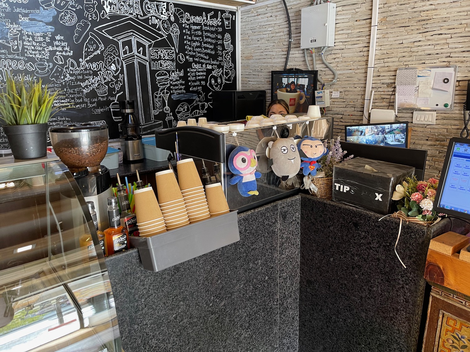 a counter with a black counter and a black and white chalkboard behind it