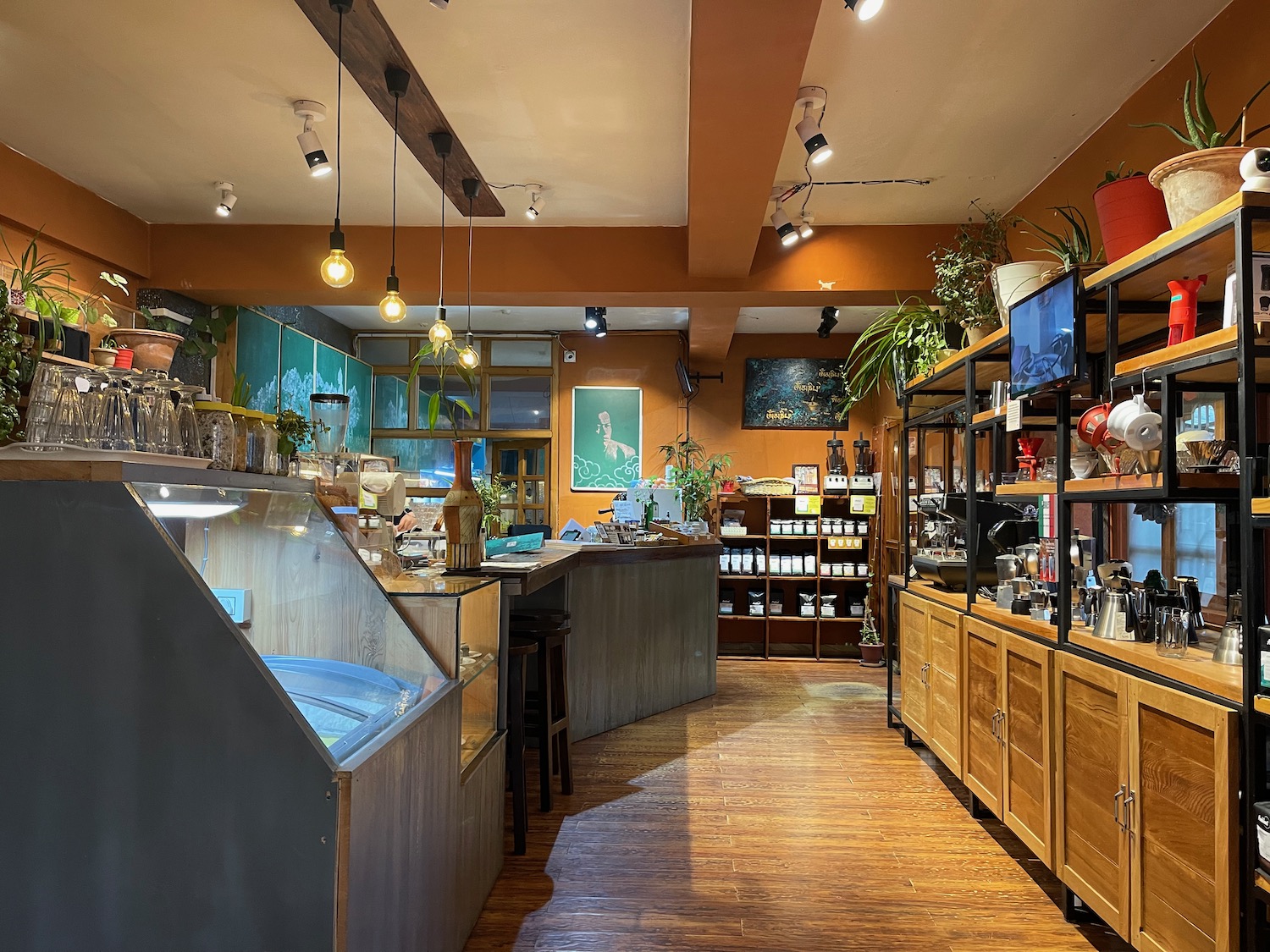 a coffee shop with shelves and lights